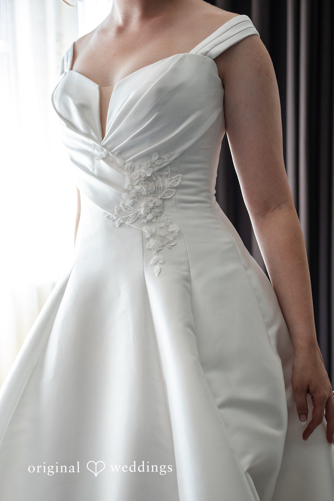Close up of the bride's satin gown