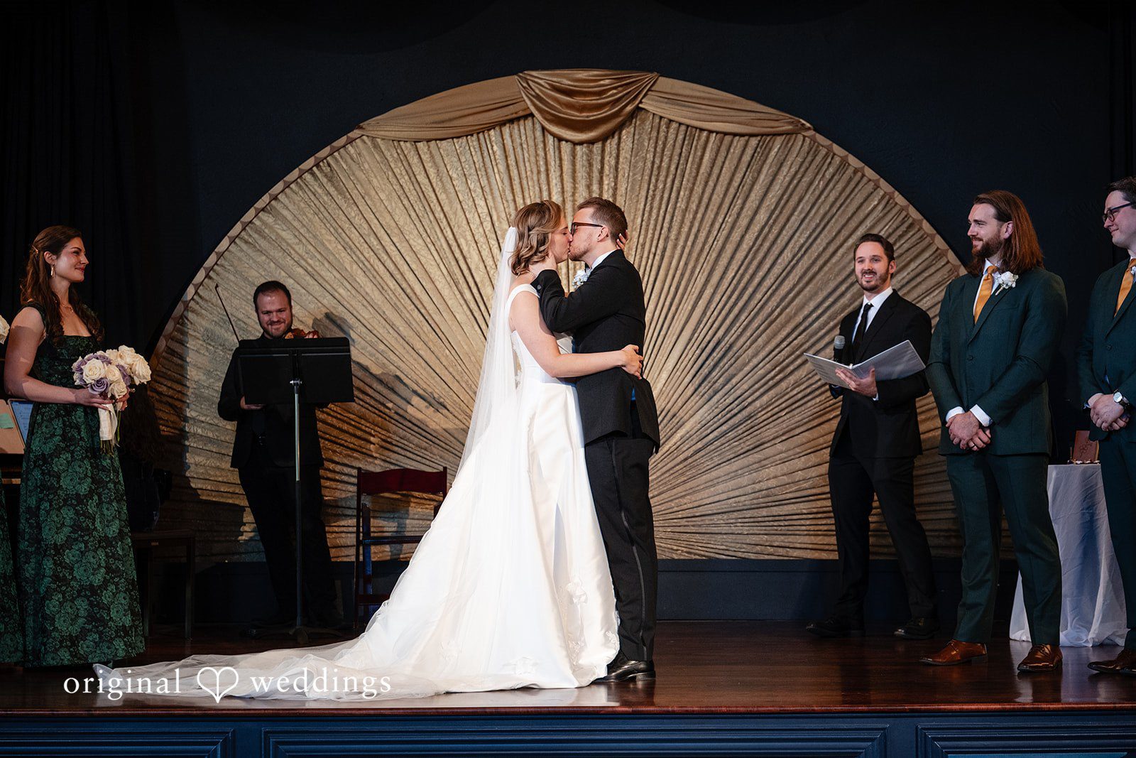 Ceremony in front of the gold fan backdrop