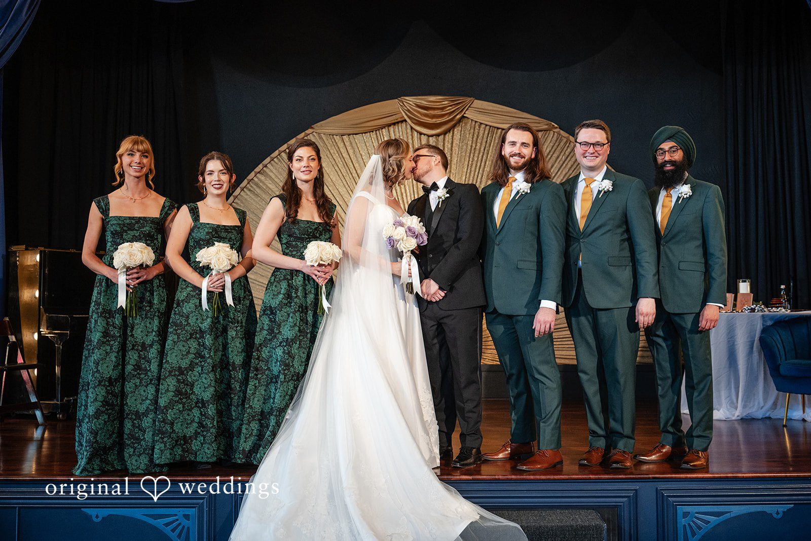 Wedding party in front of the gold fan at Reverie Ballroom