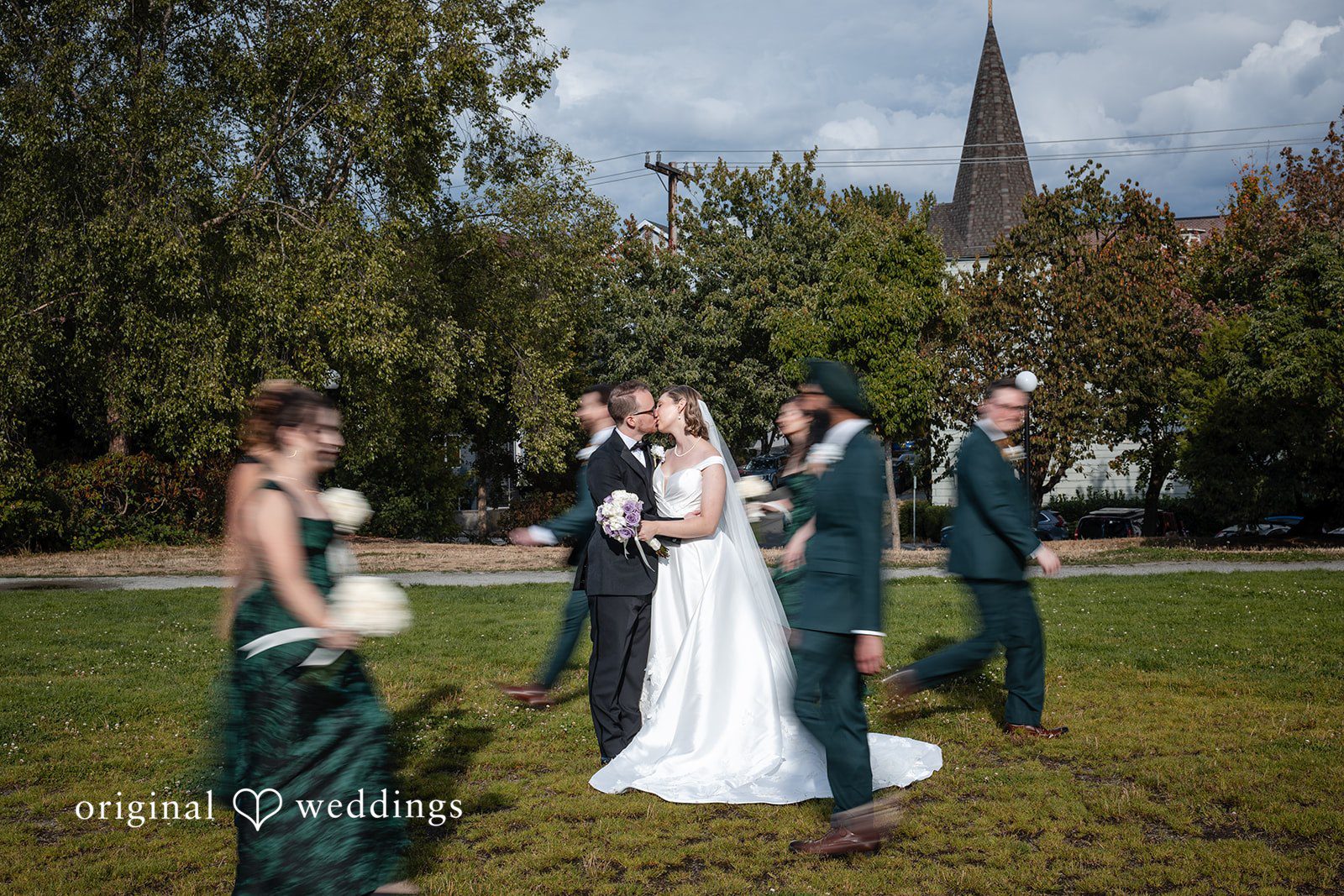 Wedding party celebrating with the couple on the lawn