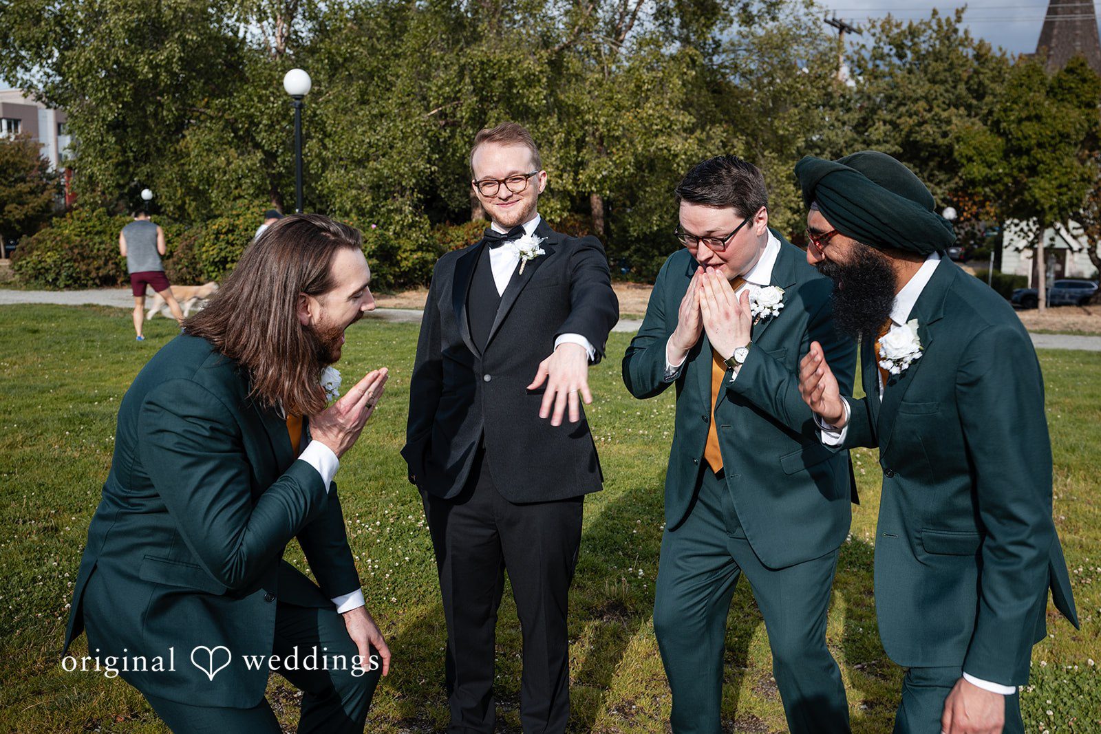 Groomsmen laughing together on the lawn