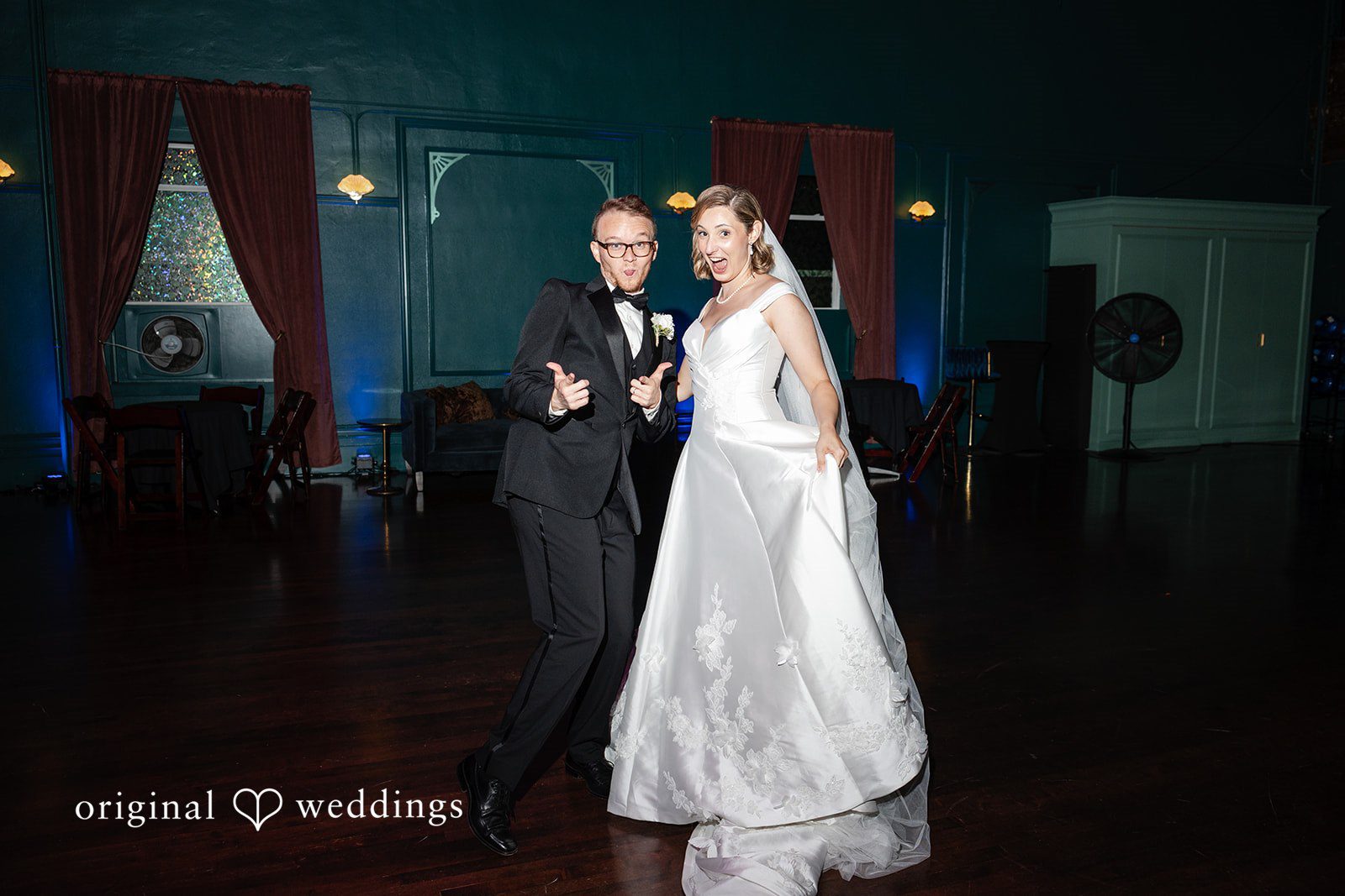 Bride and groom standing together in the dark teal hallway