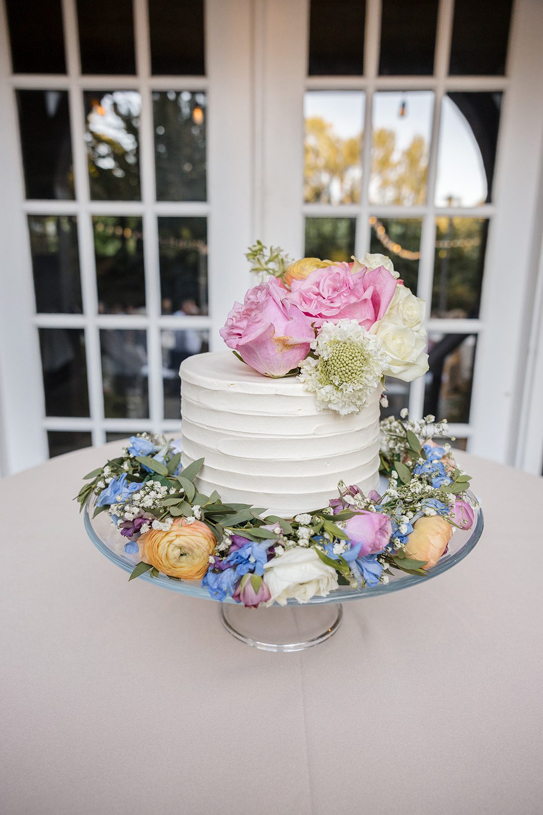 Wedding cake topped with pastel flowers