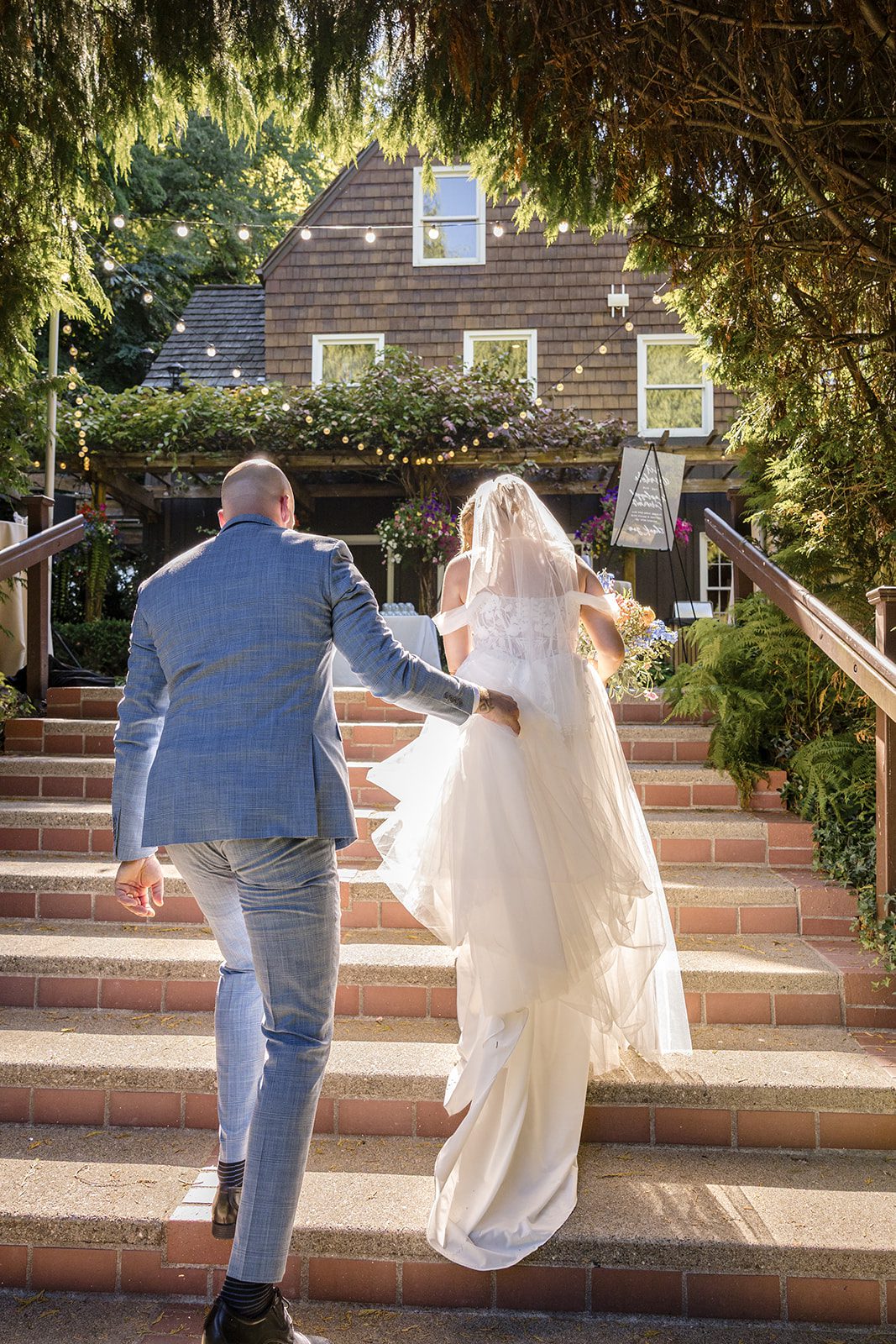Bride and groom on the brick steps at Robinswood House
