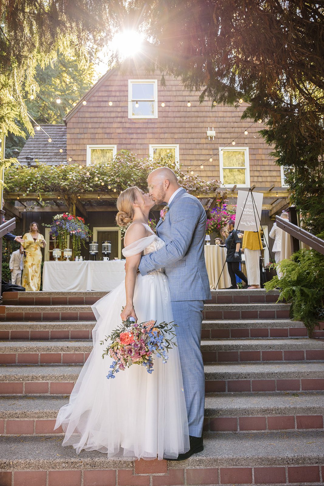 Bride and groom sharing a kiss on the steps