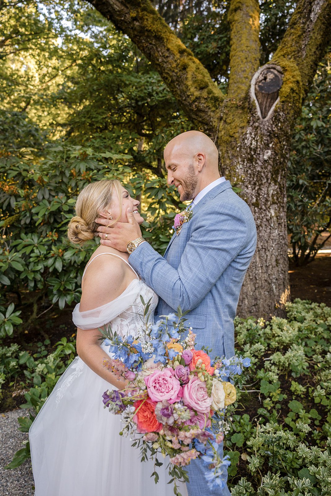 Bride and groom posing among the greenery