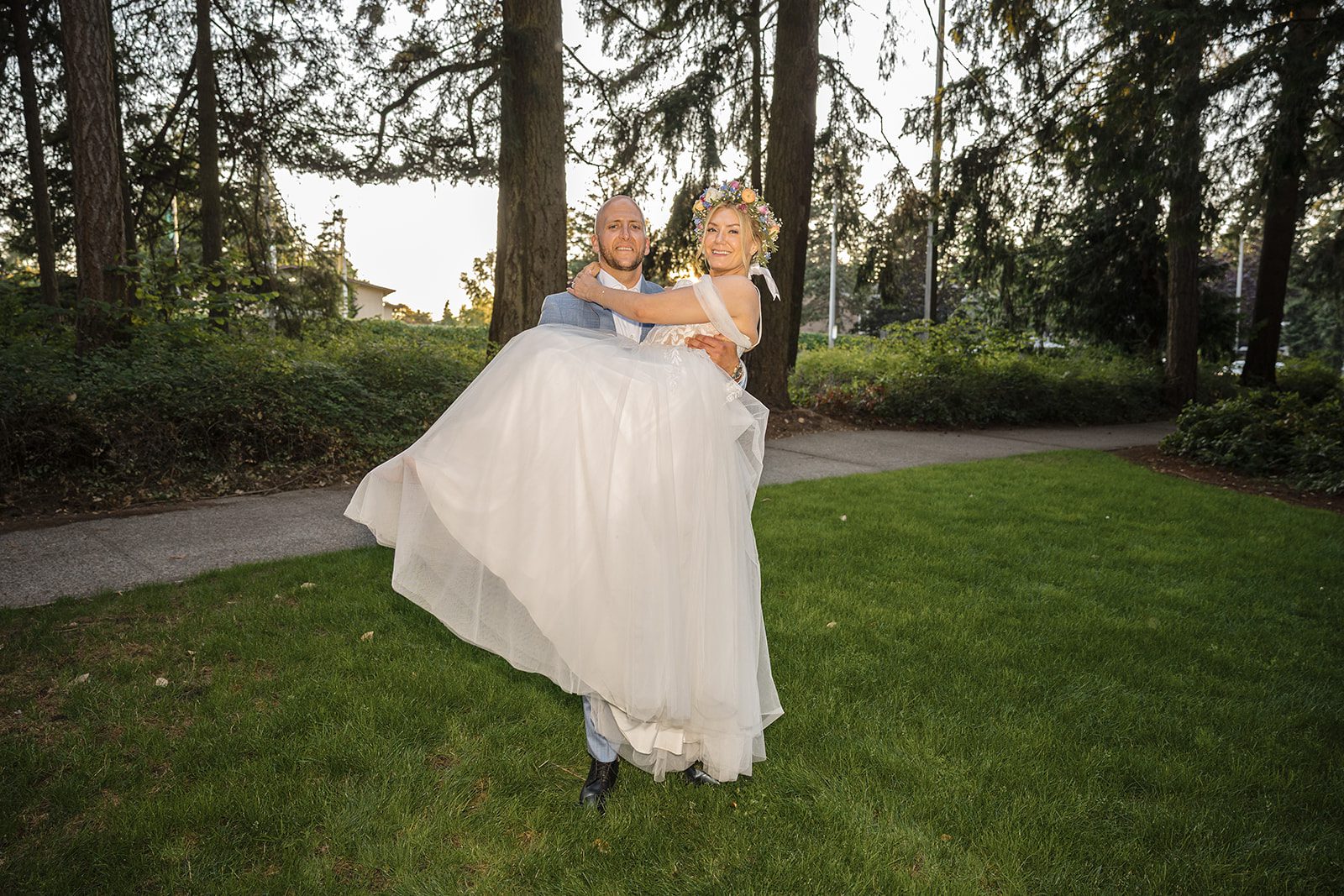 Groom twirling the bride on the lawn