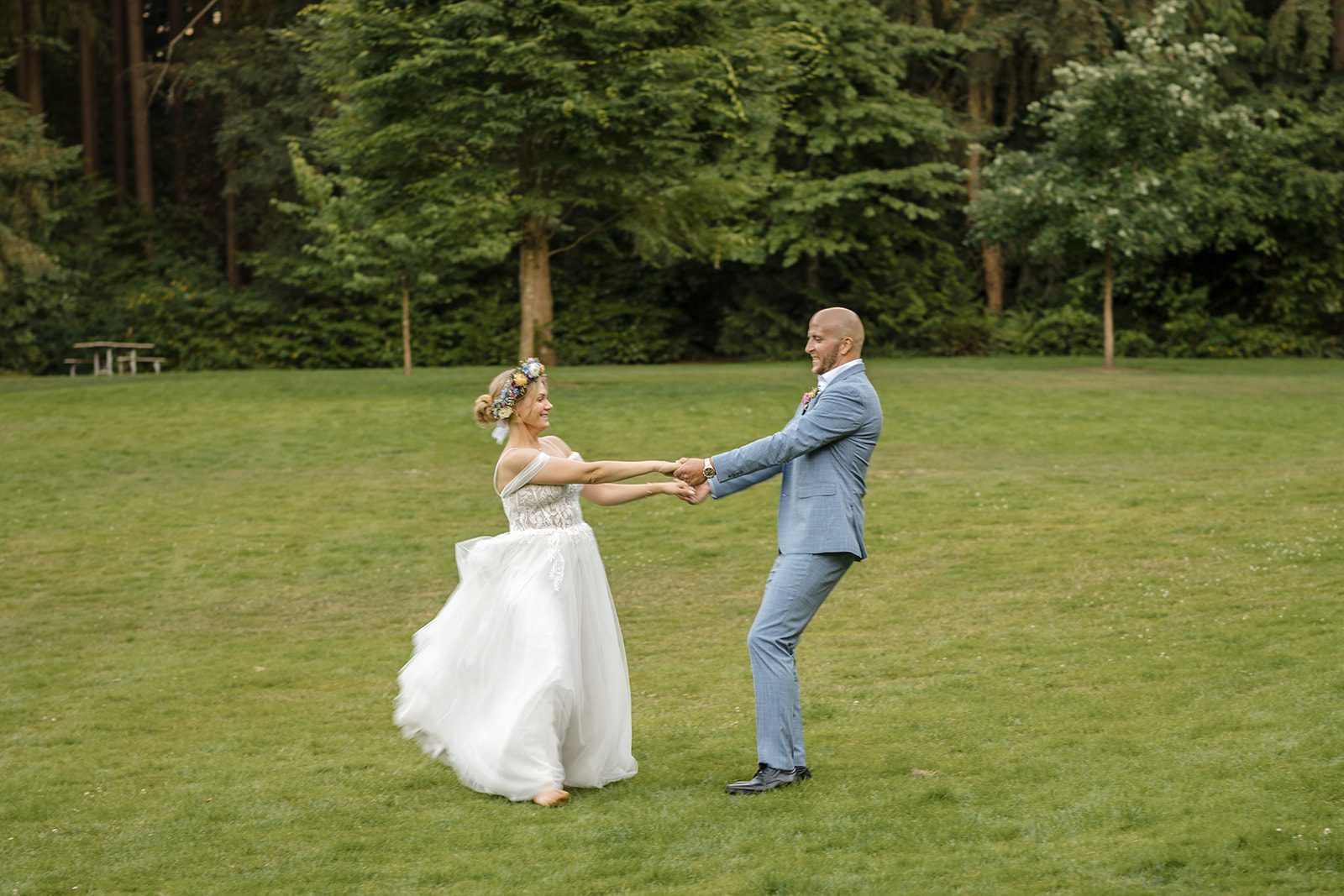 Couple dancing across the lawn at Robinswood House