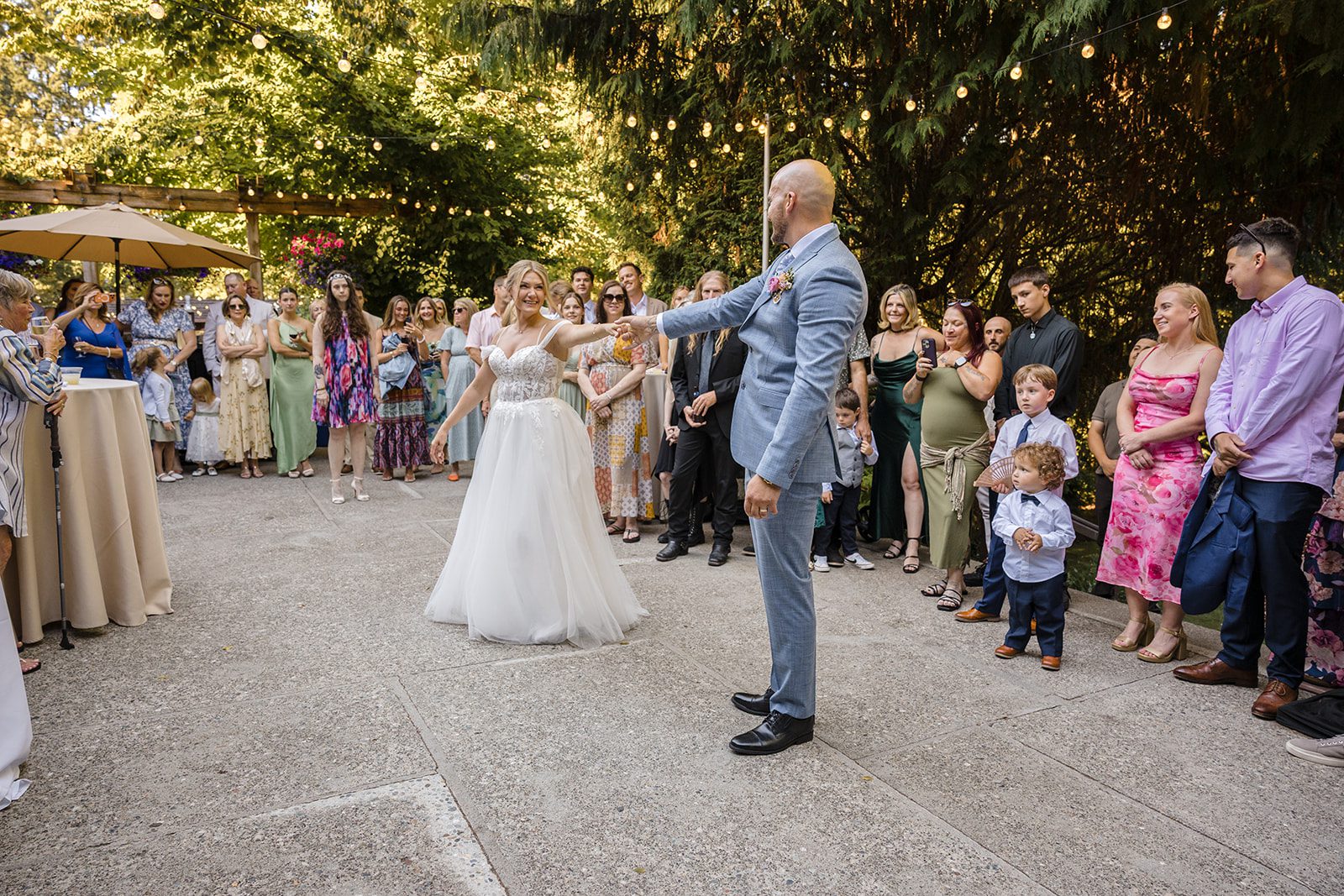 Couple dancing surrounded by guests at Robinswood House