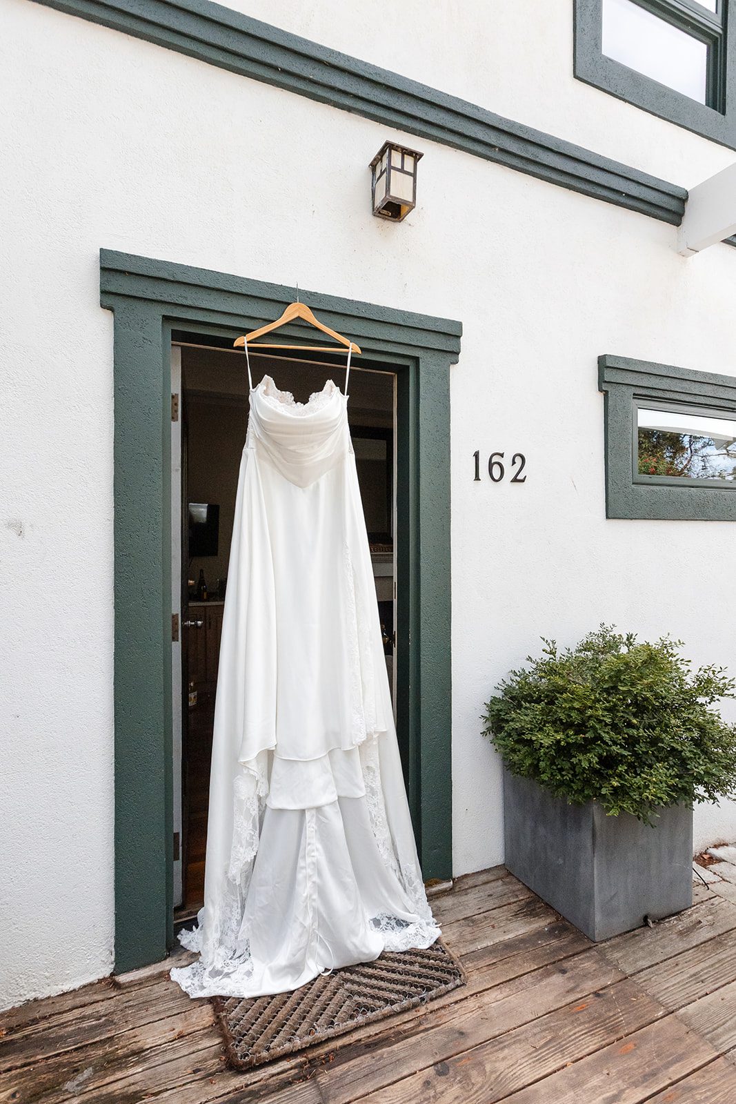 roche-harbor-resort-timeless-seattle-emma-chase-emma-chase-004-28 Wedding gown hanging outside a white building