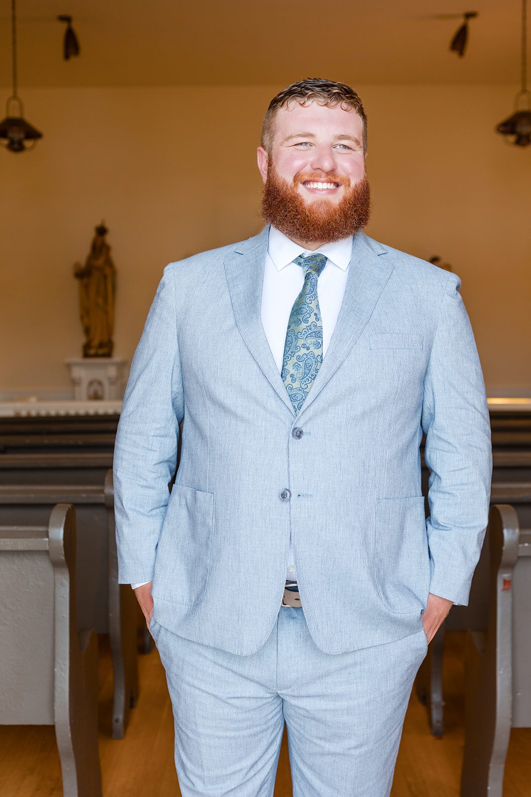 roche-harbor-resort-timeless-seattle-emma-chase-emma-chase-015-25 Groom in a light blue suit smiling