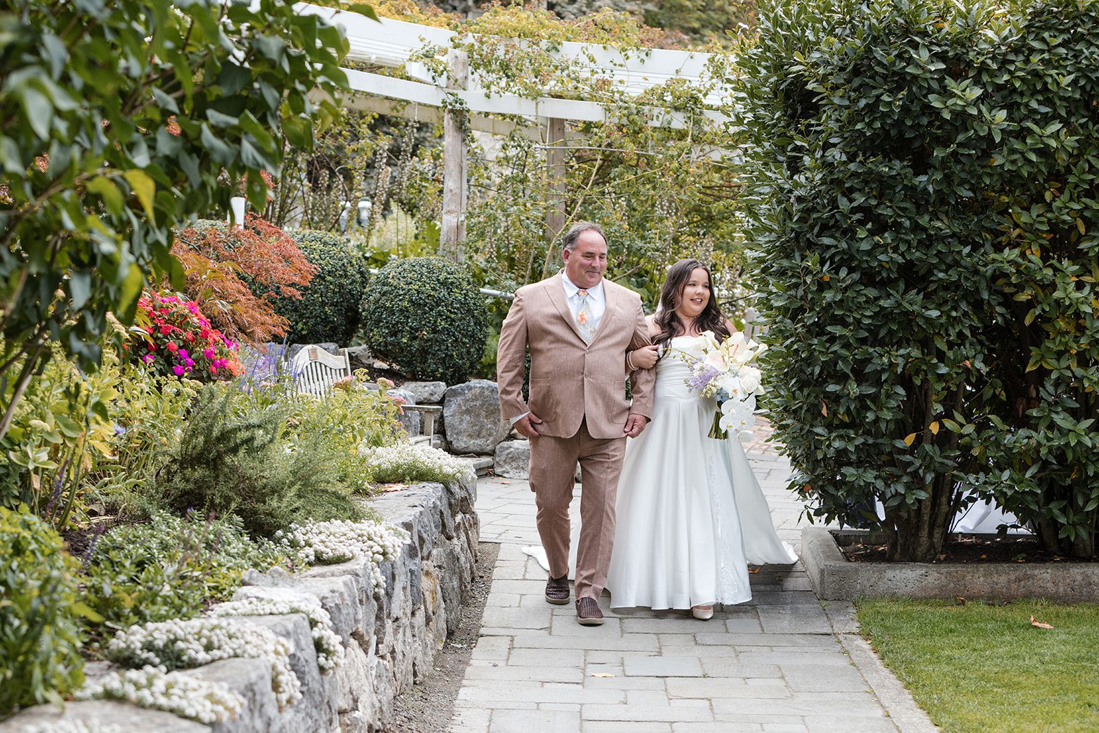 roche-harbor-resort-timeless-seattle-emma-chase-emma-chase-017-07 Bride walking down the garden path with her father