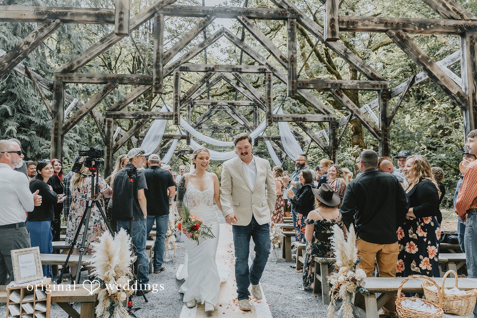 Kailyn + Tony Couple walking back up the aisle as guests cheer at Samara Farm