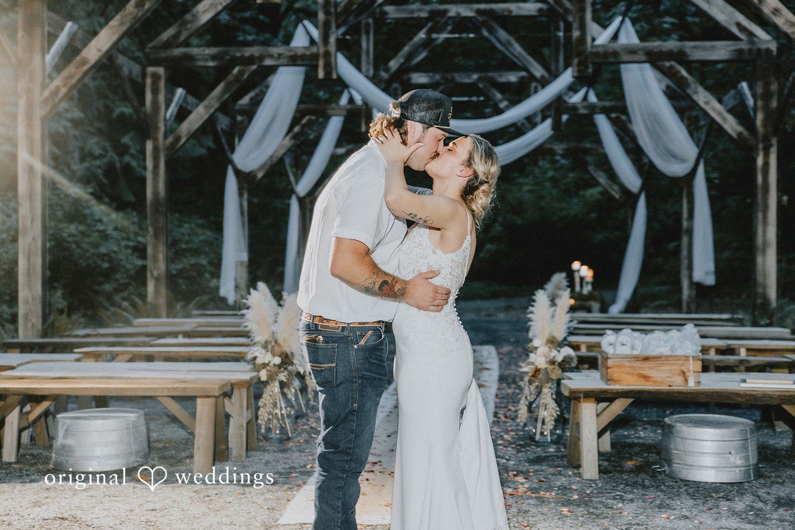 Kailyn + Tony Couple kissing under the wooden ceremony structure