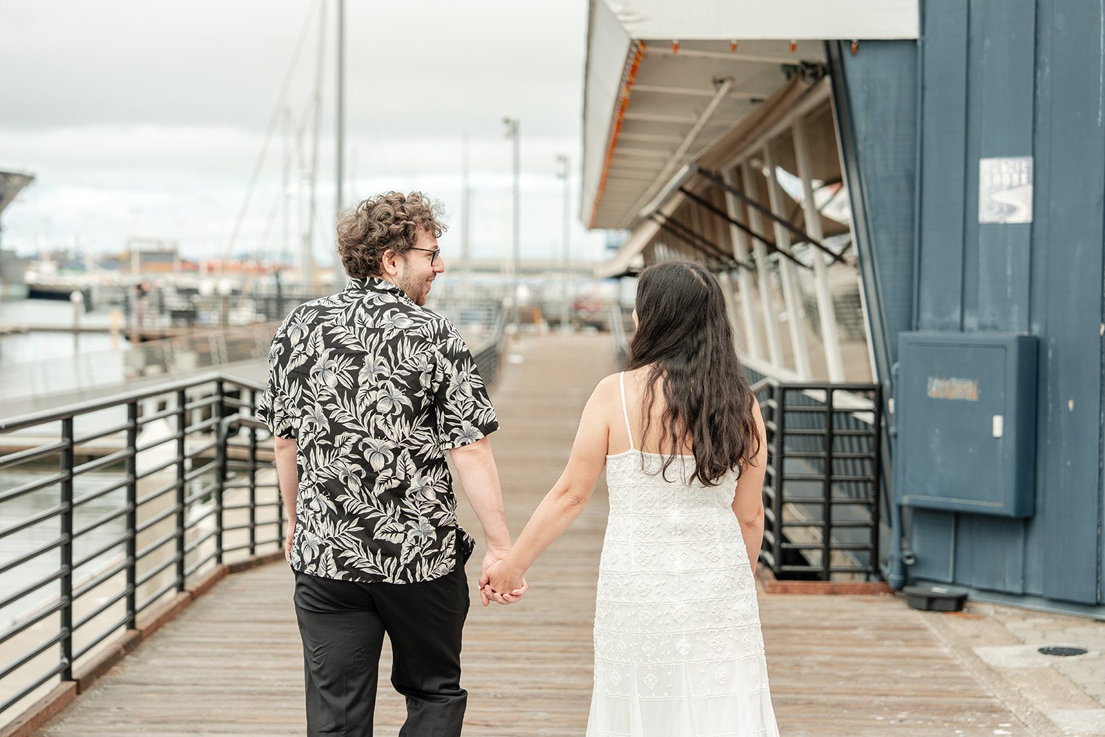 scotts-seafood-grill-bar-timeless-san-francisco-libby-ethan-p007-15 Couple walking hand in hand on the pier
