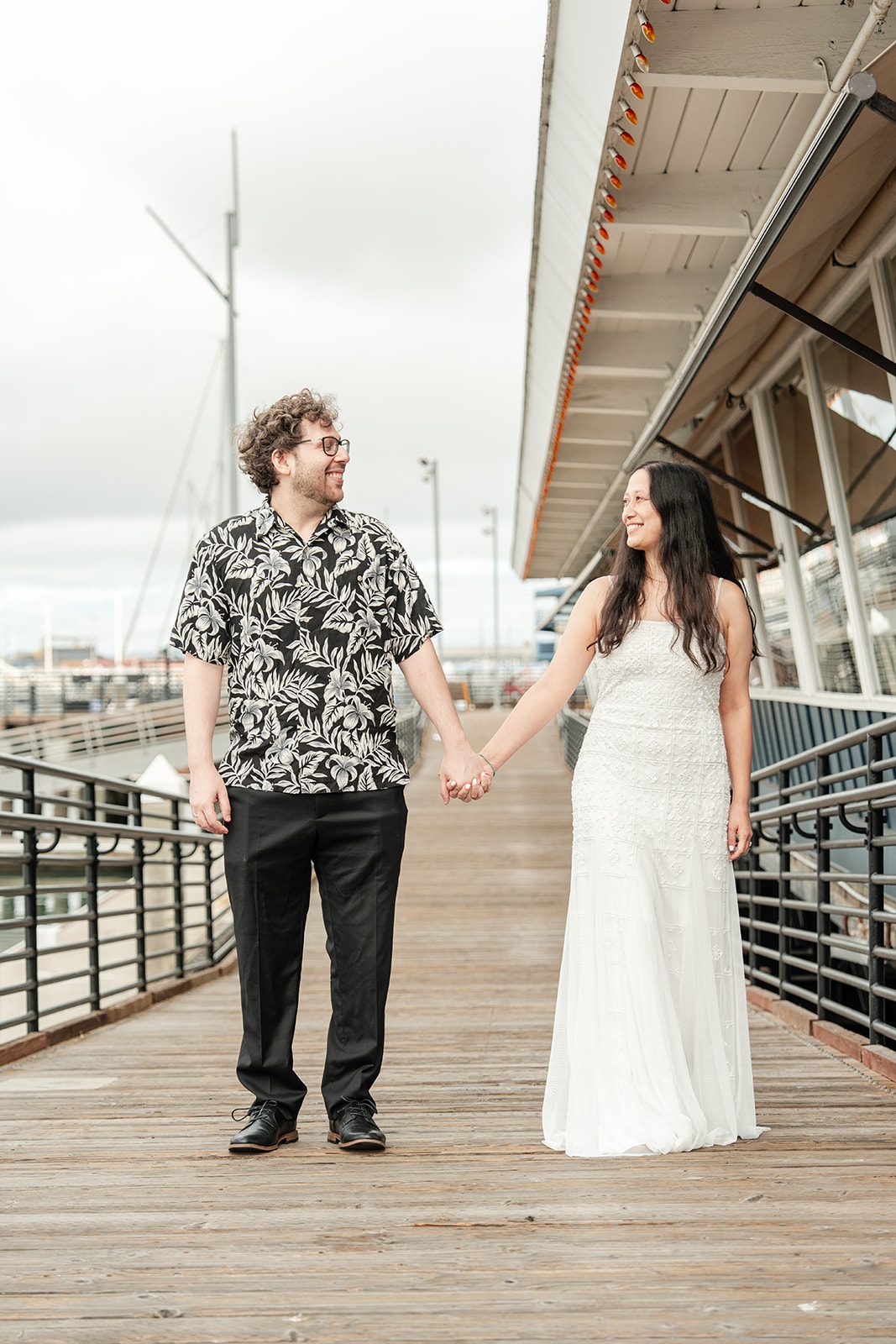 scotts-seafood-grill-bar-timeless-san-francisco-libby-ethan-p009-14 Newlyweds walking together along the marina at Scott's Seafood Grill & Bar