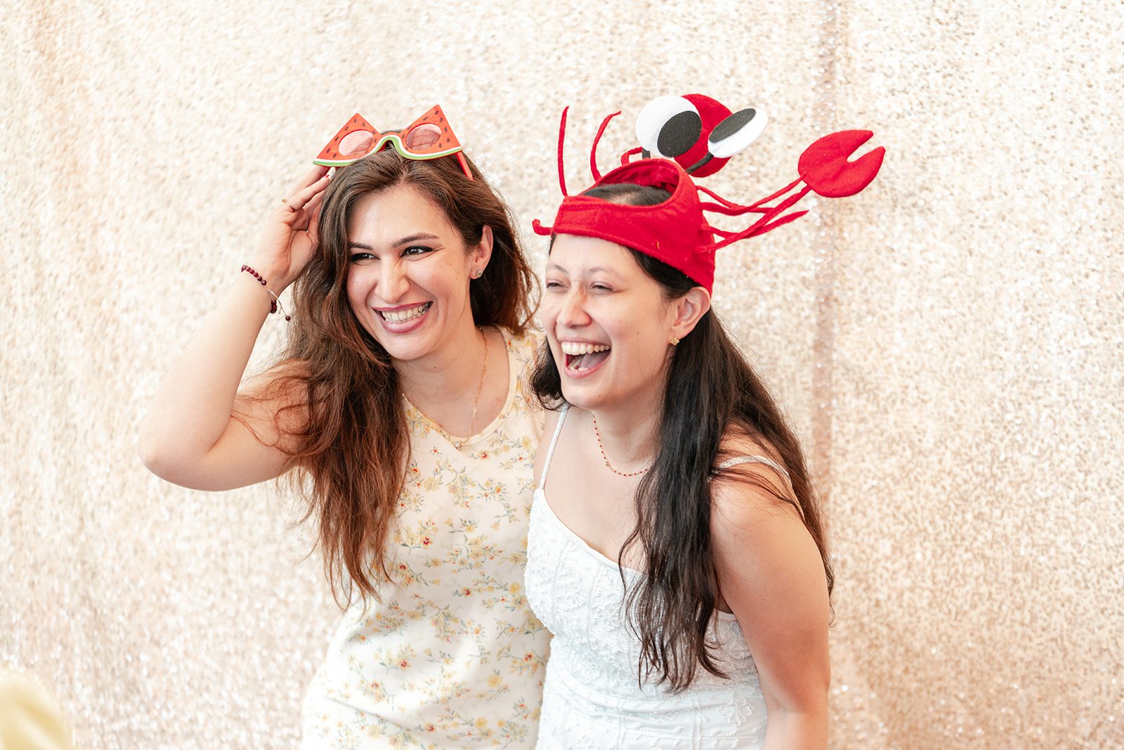 scotts-seafood-grill-bar-timeless-san-francisco-libby-ethan-p013-08 Bride laughing with a friend in a festive hat