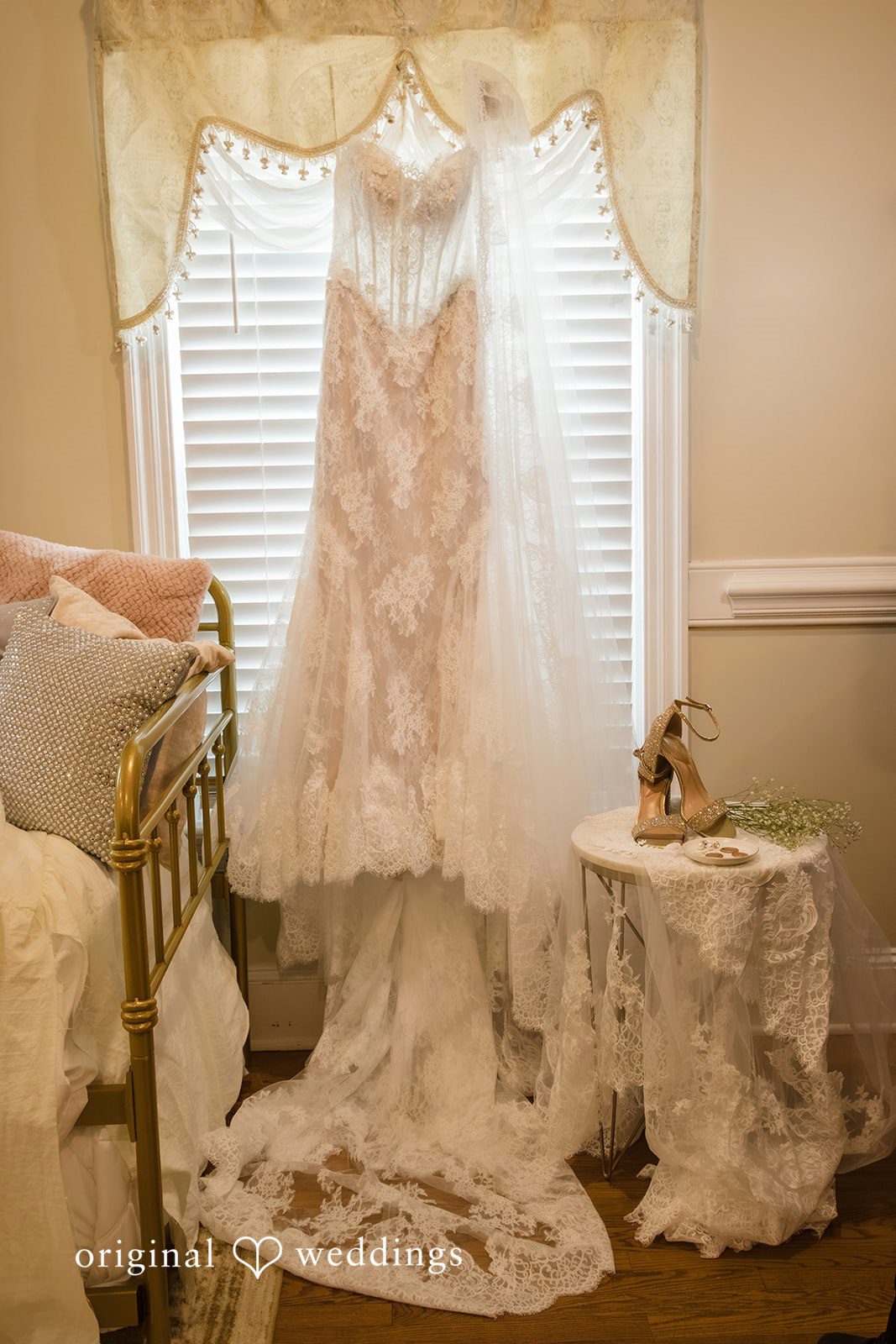 Holly + Adam Wedding gown hanging by the window by Raleigh wedding photographers at Seven Paths Manor