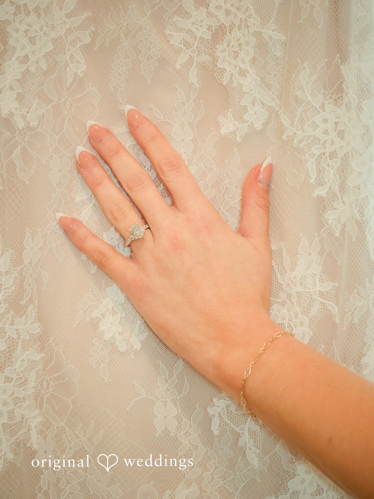 Holly + Adam Bride's ring hand on her lace dress