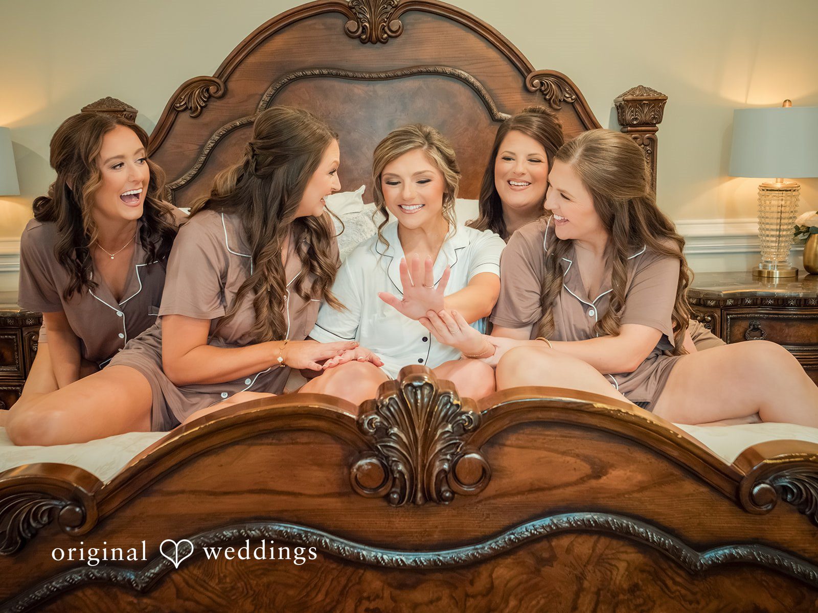 Holly + Adam Bride with her bridesmaids on the bed
