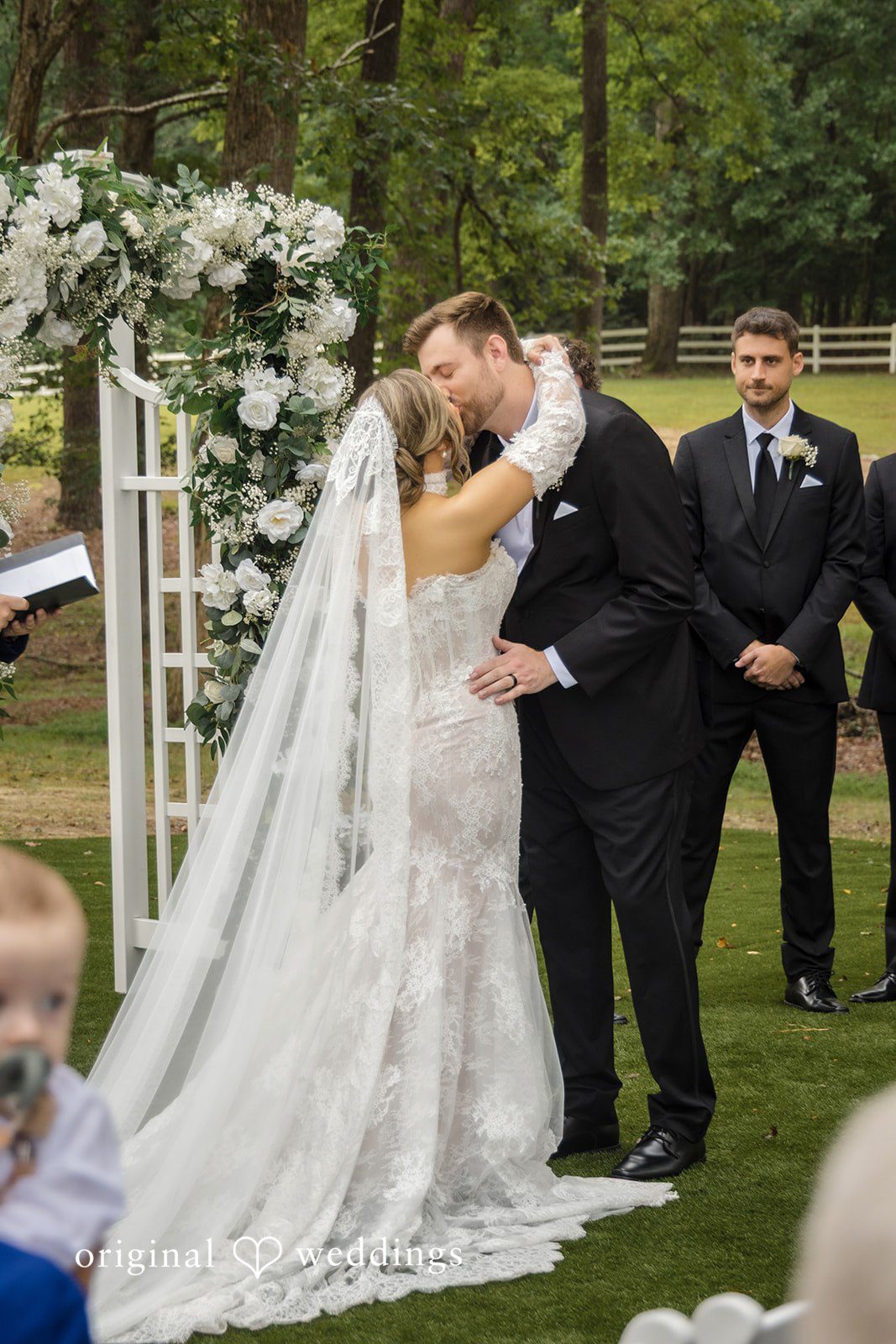 Holly + Adam Couple kissing at the arch at Seven Paths Manor
