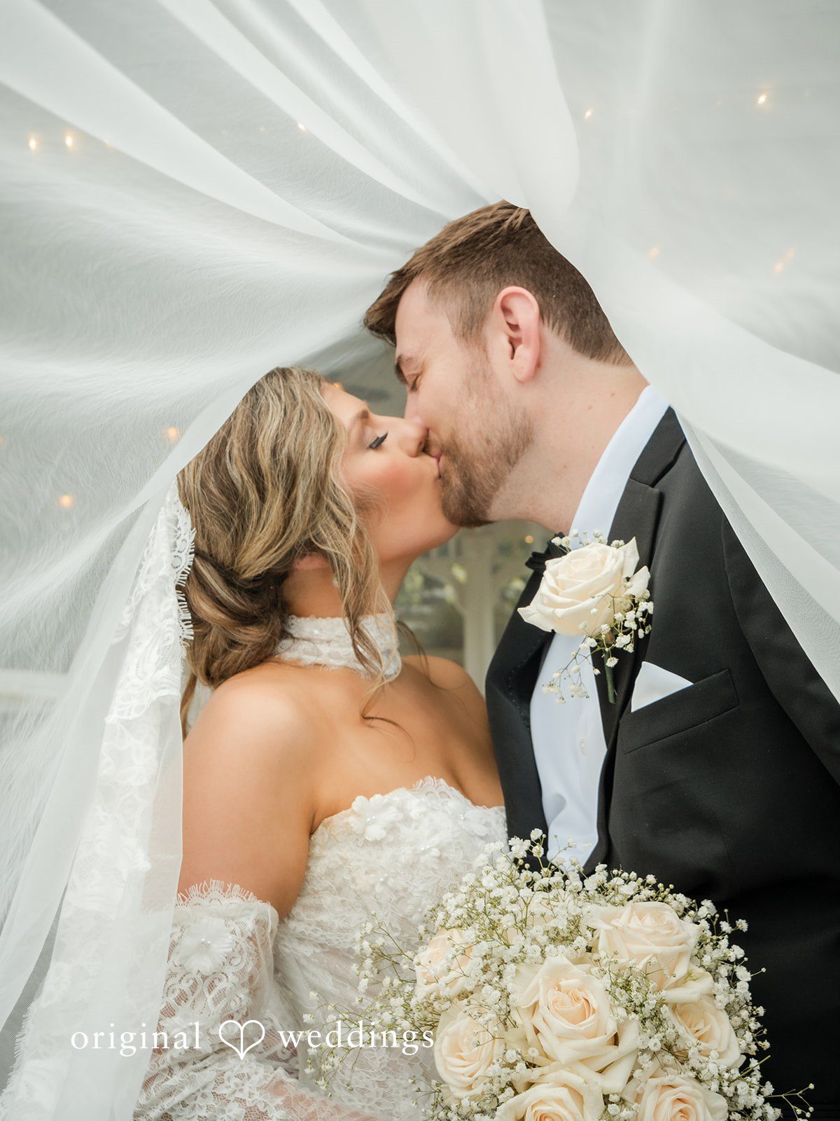 Holly + Adam Couple kissing under the veil