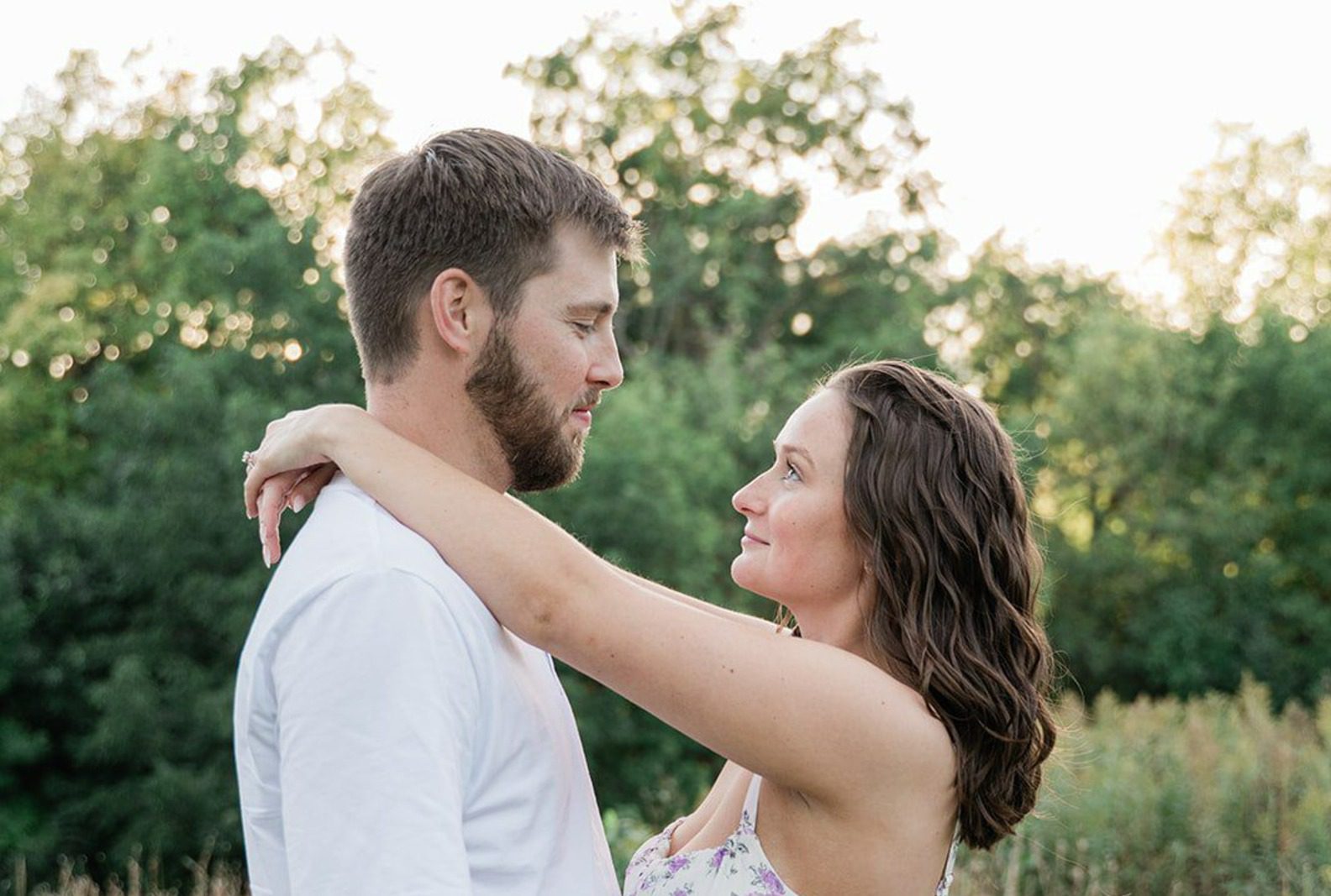 Couple embracing in the prairie, captured with Engagement Photography Services from Original Weddings at Silverwood Park