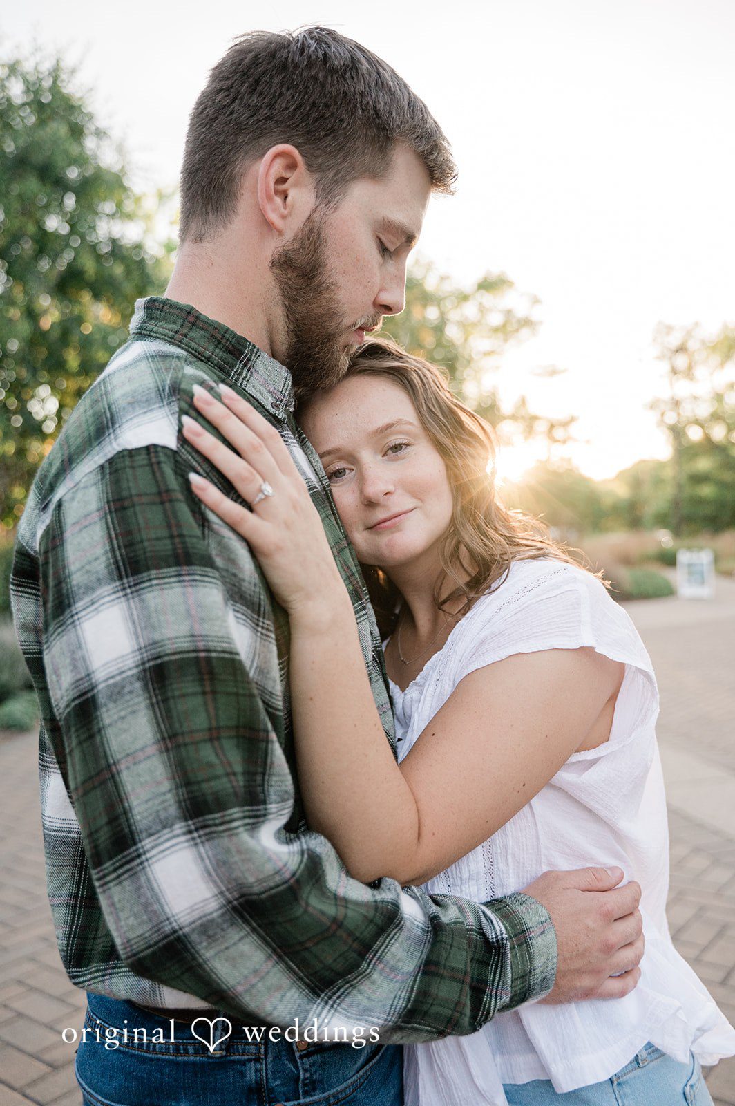 Jada + Nathan Couple embracing on the lakeside path at Silverwood Park