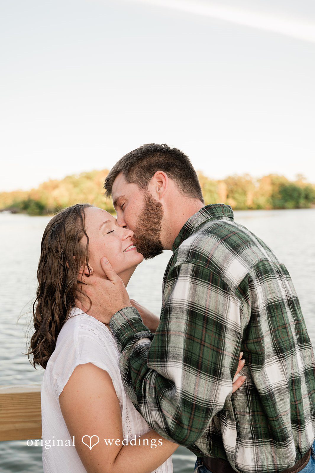Jada + Nathan Couple kissing by the lake at Silverwood Park