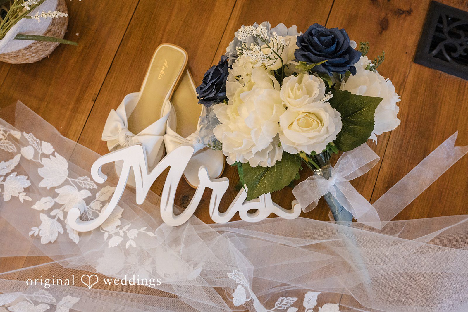 Faith + Brandon Mrs sign with white and blue flowers