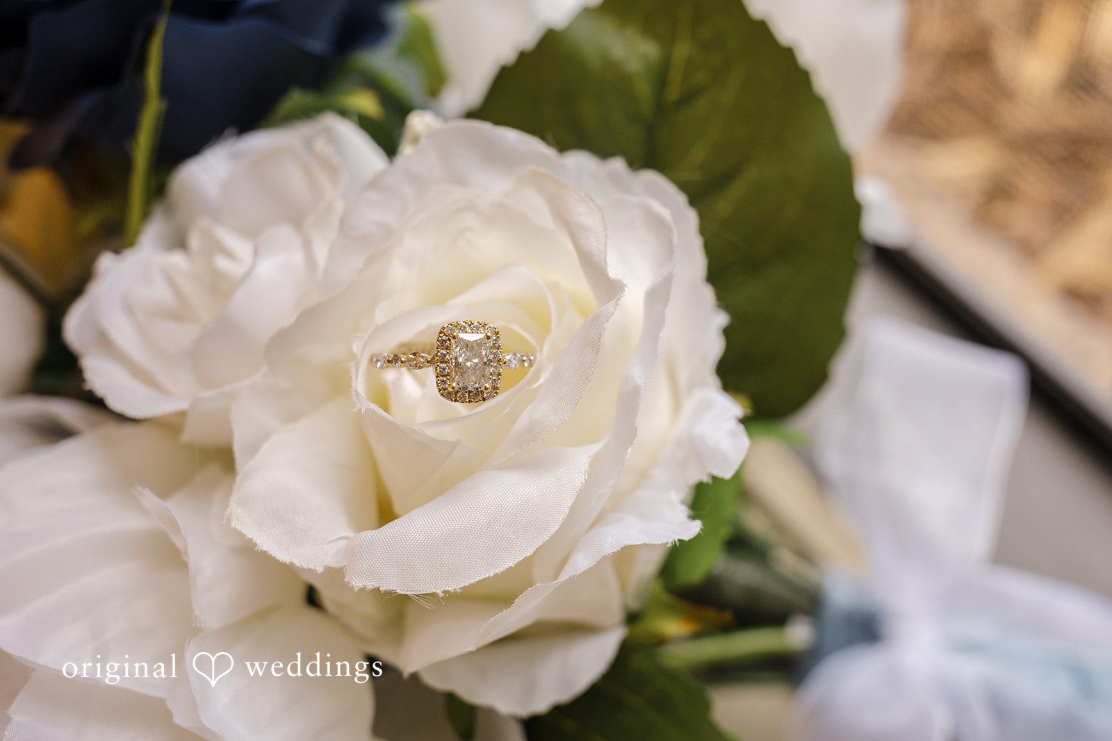 Faith + Brandon Wedding ring resting on a white flower