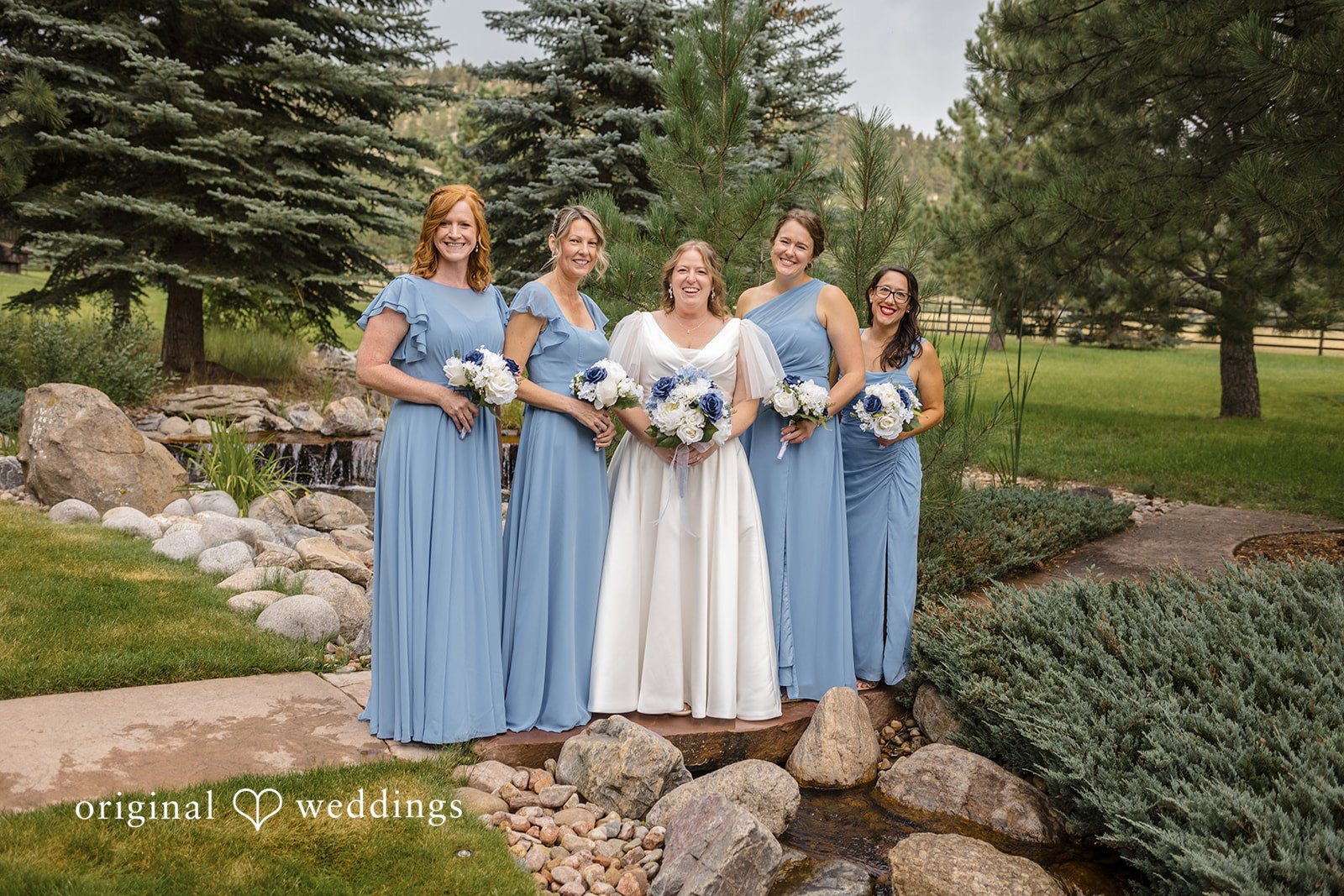 Faith + Brandon Bride with her bridesmaids outdoors at Spruce Mountain Ranch