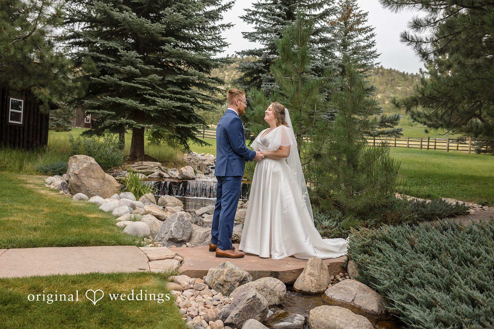 Faith + Brandon Couple by the rocks and evergreens at Spruce Mountain Ranch