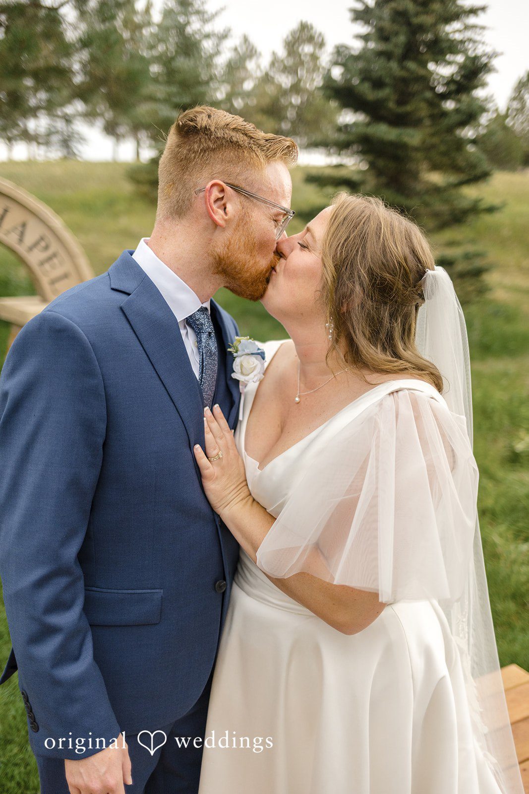 Faith + Brandon Couple kissing among the pines