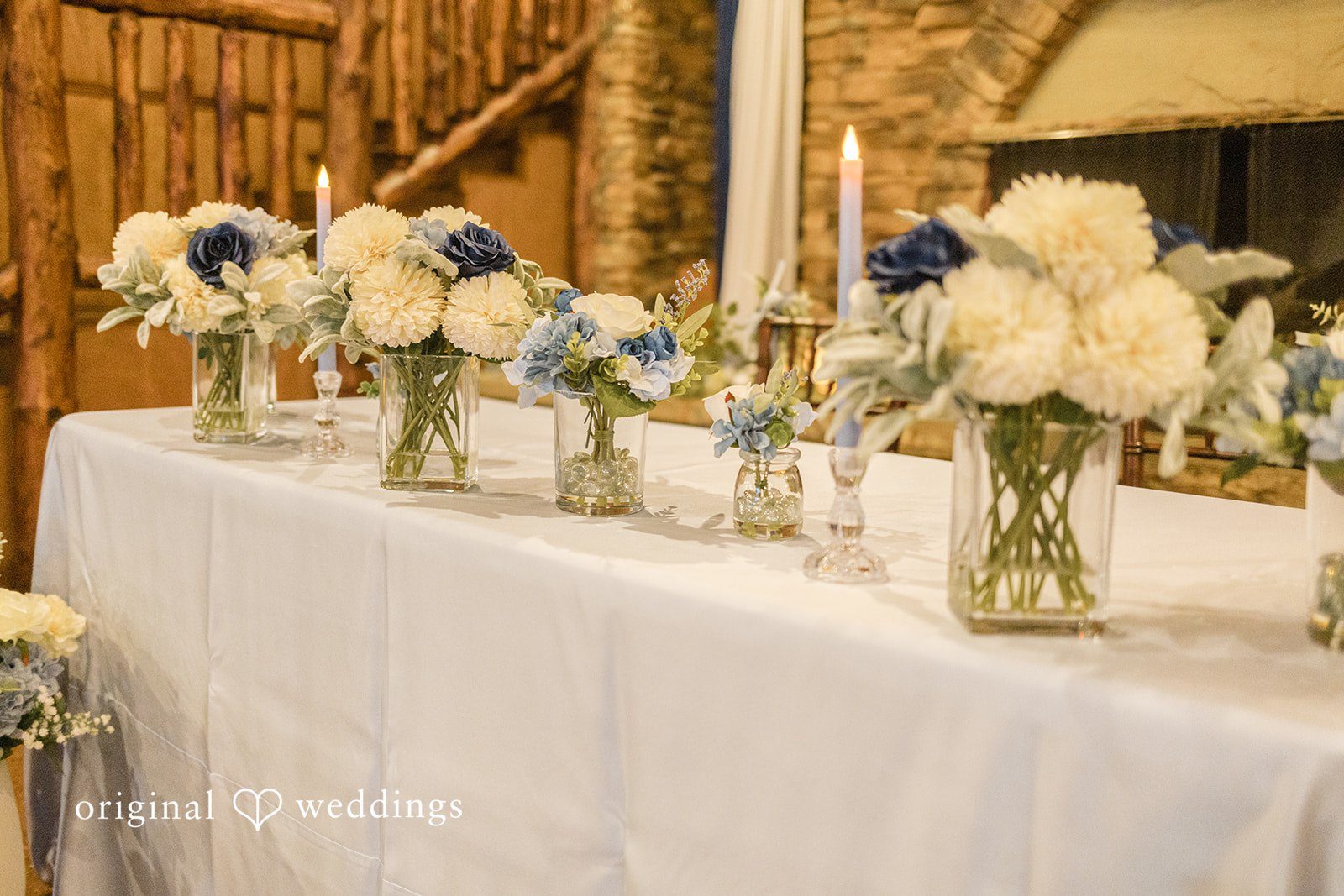Faith + Brandon Reception table with white flowers and candles