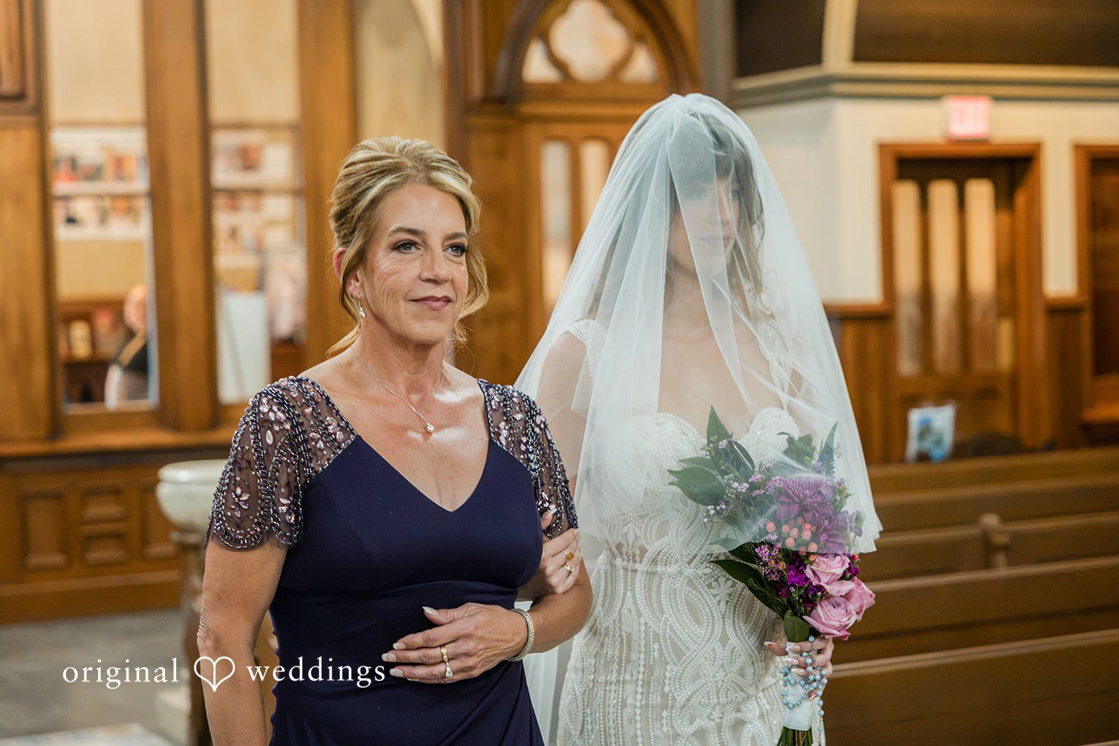 Bride walking down the aisle with her mother
