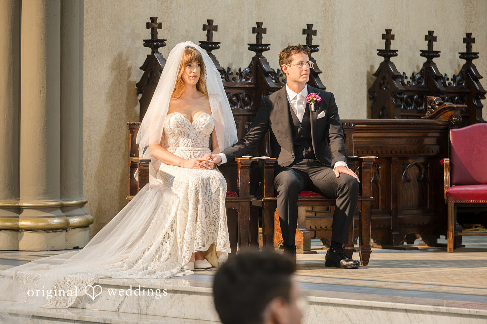 Couple seated near the altar during Mass at St John the Evangelist Catholic Church
