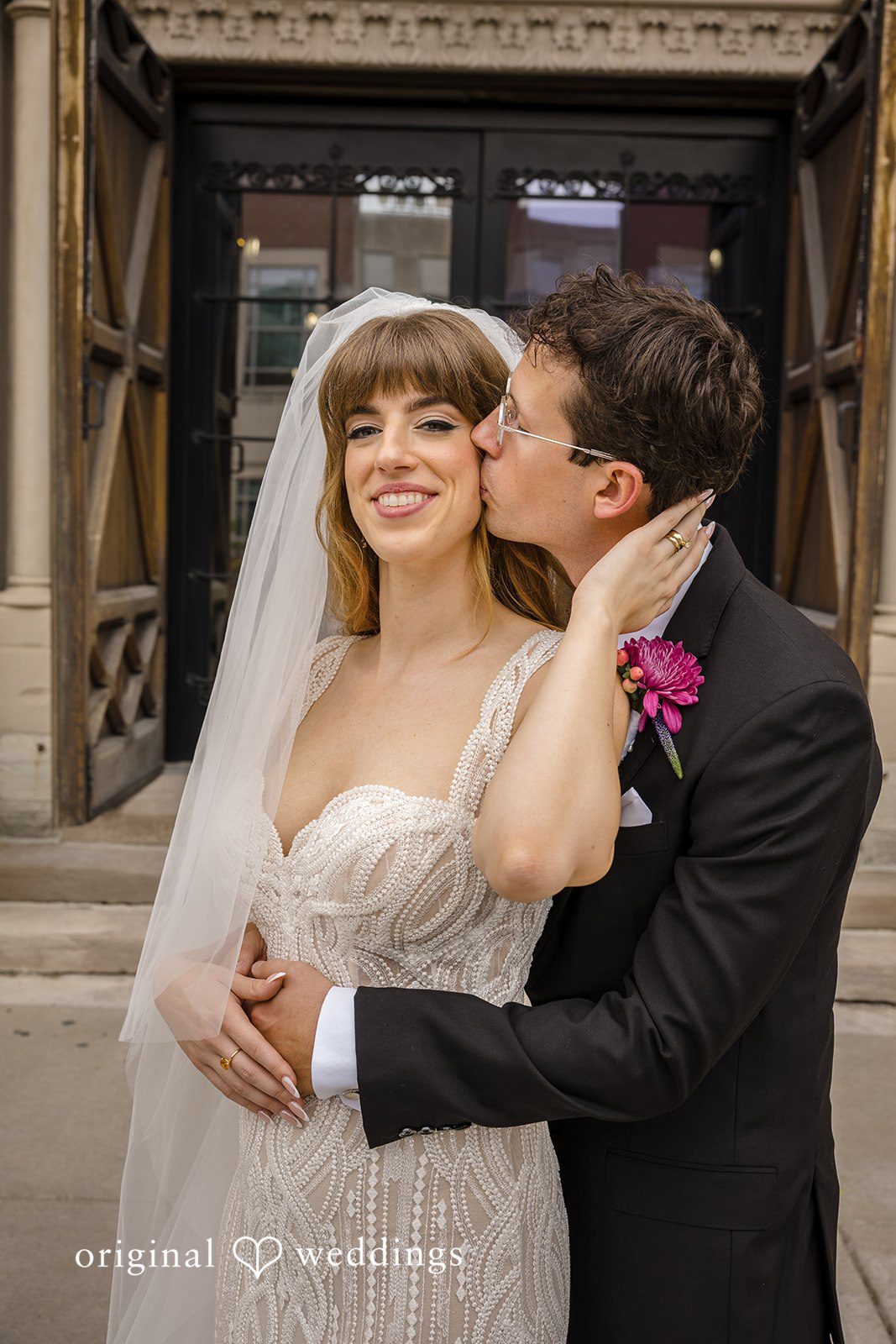 Groom kissing the bride on the cheek