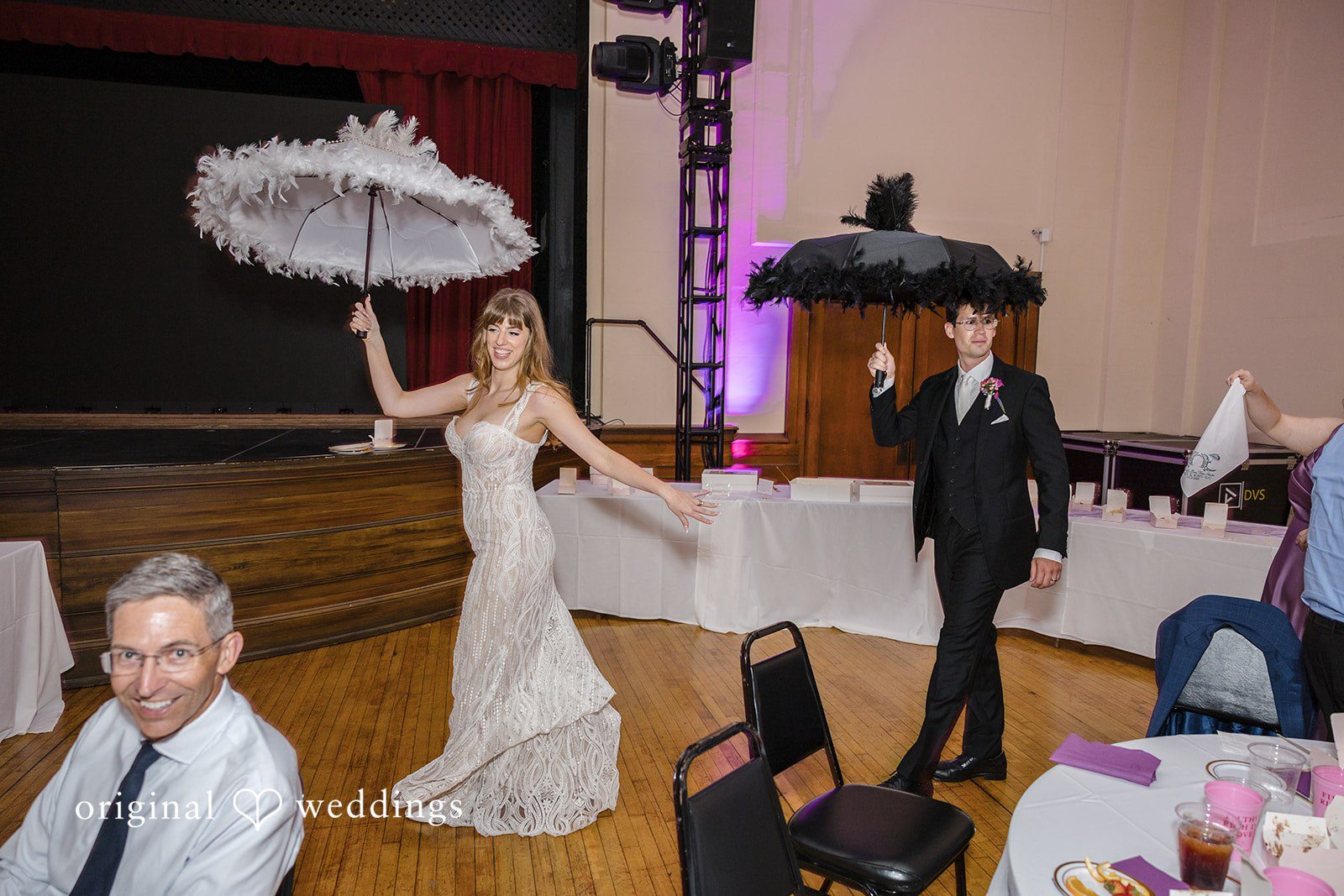 Bride leading a festive parade with a decorated umbrella