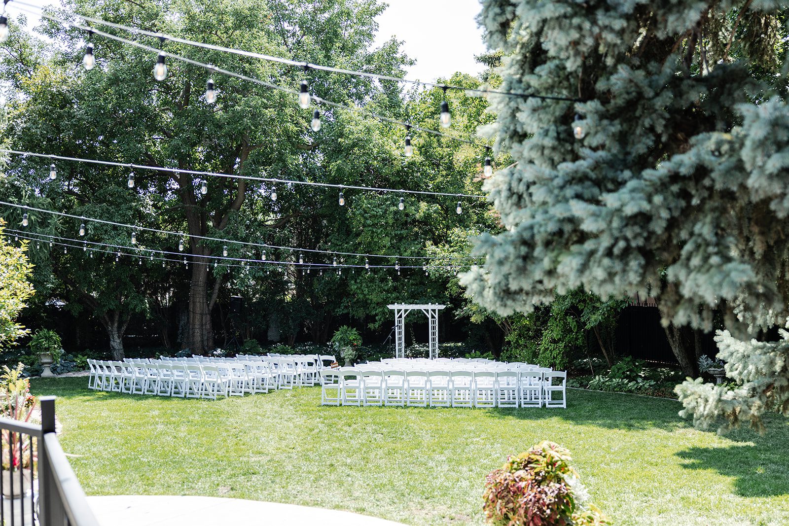 Garden ceremony setup with white chairs at St. Paul College Club Garden ceremony setup with white chairs at St. Paul College Club