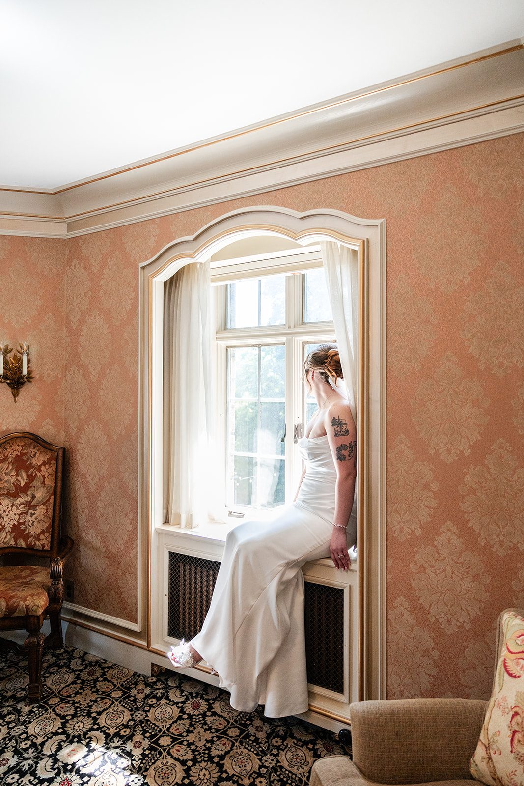 Bride getting ready by the window Bride getting ready by the window