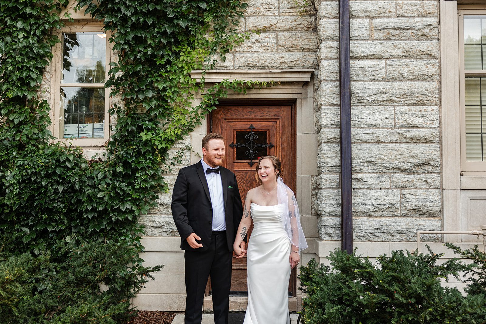 Bride and groom at the front doors at St. Paul College Club Bride and groom at the front doors at St. Paul College Club