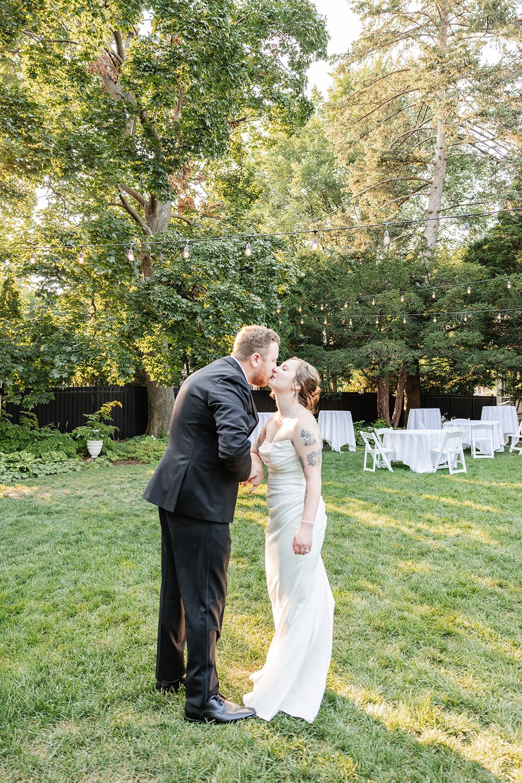 Groom twirling the bride on the lawn Groom twirling the bride on the lawn