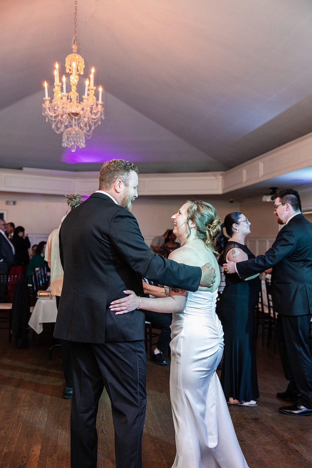 Couple dancing under the chandelier Couple dancing under the chandelier