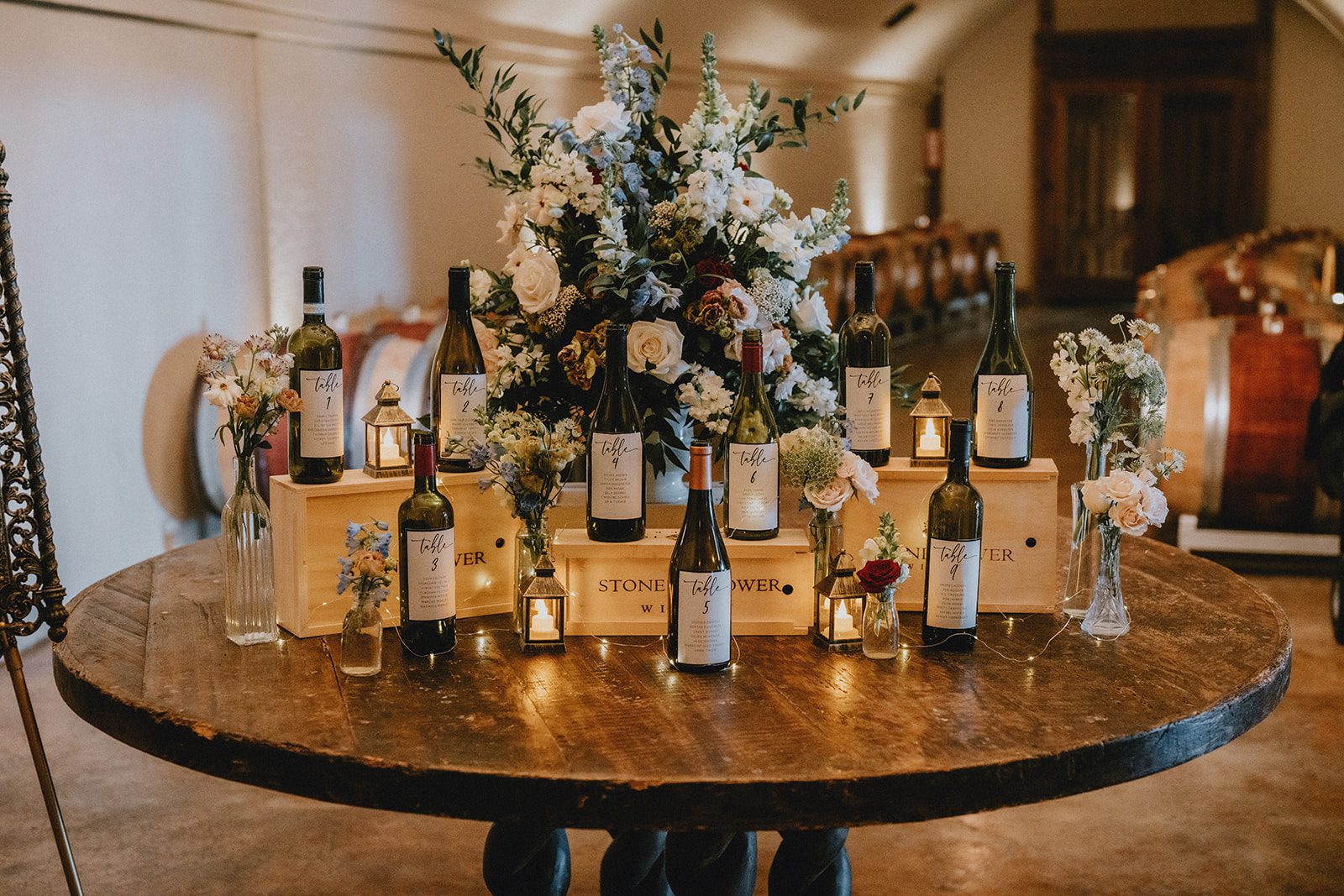 stone-tower-winery-rustic-washington-dc-nikkie-tyler-p006-10 Wine bottle escort display on a barrel table