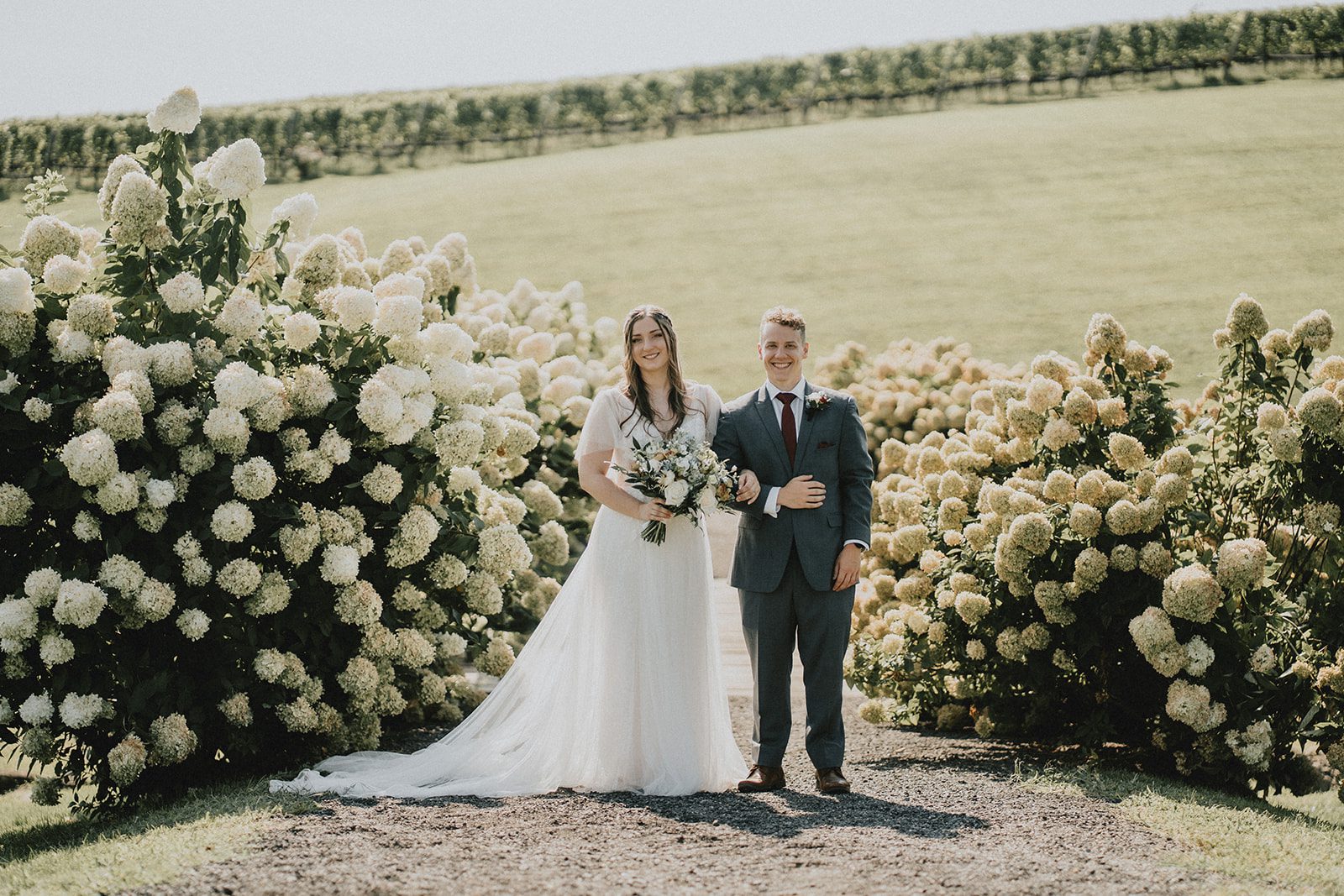 stone-tower-winery-rustic-washington-dc-nikkie-tyler-p033-04 Couple framed by hydrangeas at Stone Tower Winery