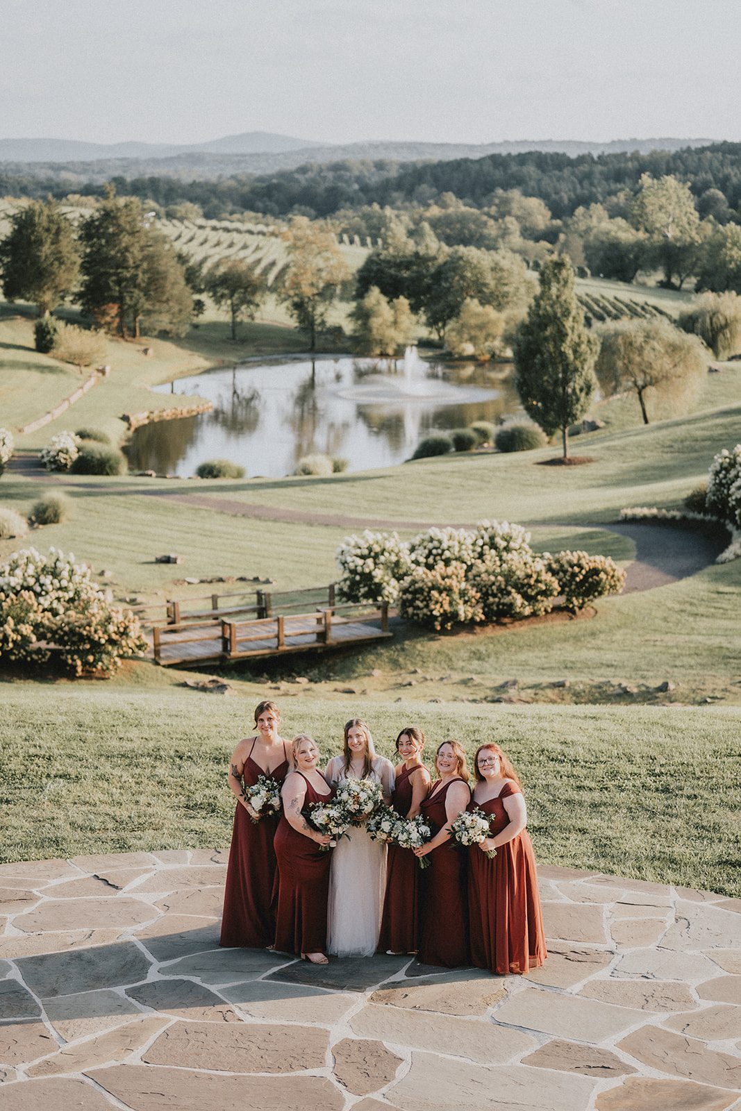 stone-tower-winery-rustic-washington-dc-nikkie-tyler-p041-11 Bridesmaids in merlot dresses with the vineyard behind them