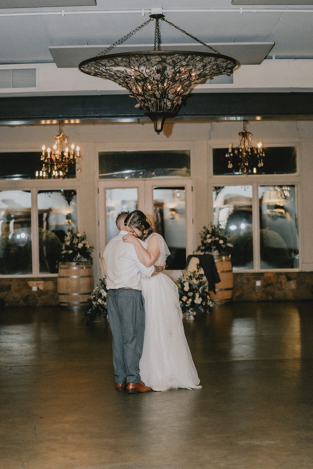 stone-tower-winery-rustic-washington-dc-nikkie-tyler-p052-03 Couple dancing beneath the chandelier