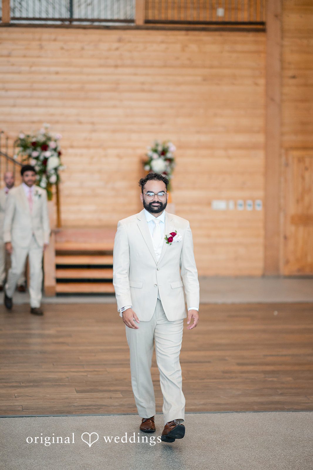 The groom walks down the aisle