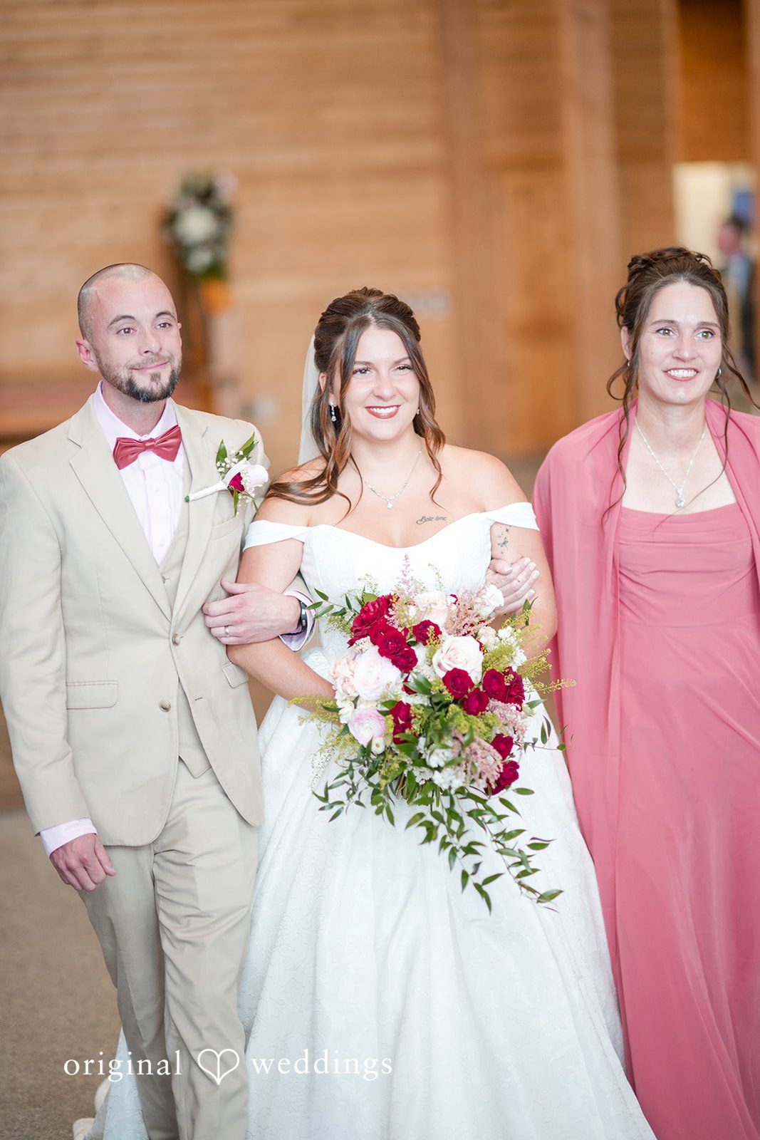 The bride's family walk her down the aisle